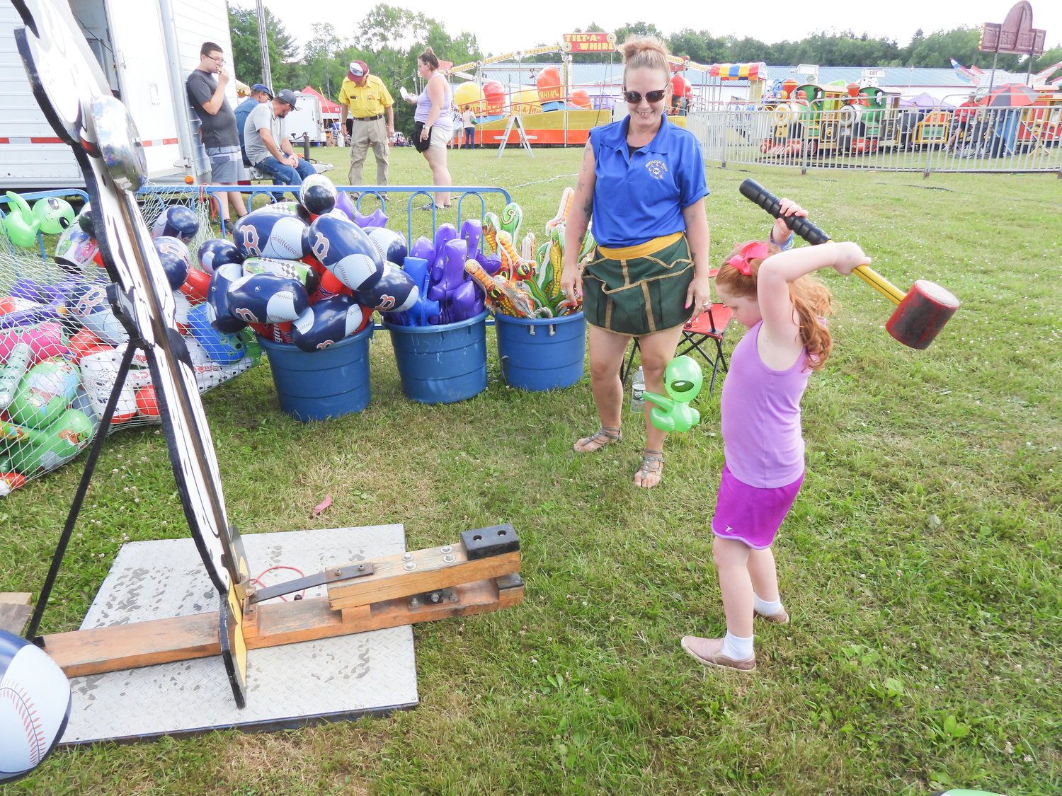 Pictured is four-year-old Carly Gibson of West Winfield, readying her hammer for the strength tester. The Madison County Fair runs until July 10.