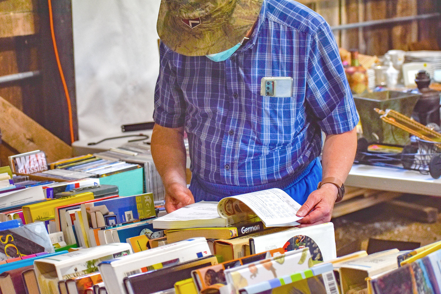 A shopper flips through a book at the Great Swamp Conservancy garage sale.