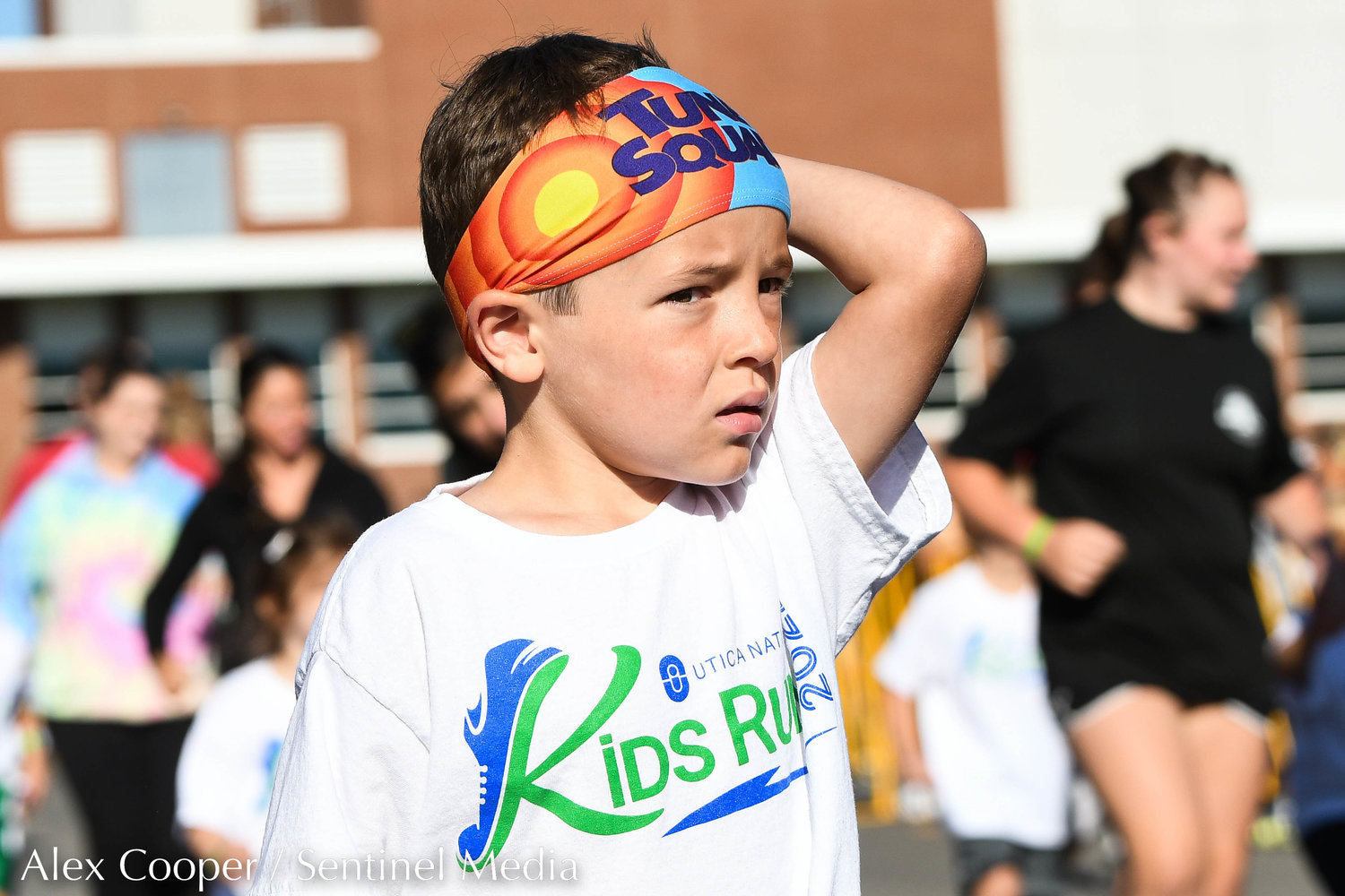 A young boy wears a Tune Squad headband while participating in the Utica National Kids Run at Mohawk Valley Community College in Utica on Saturday.