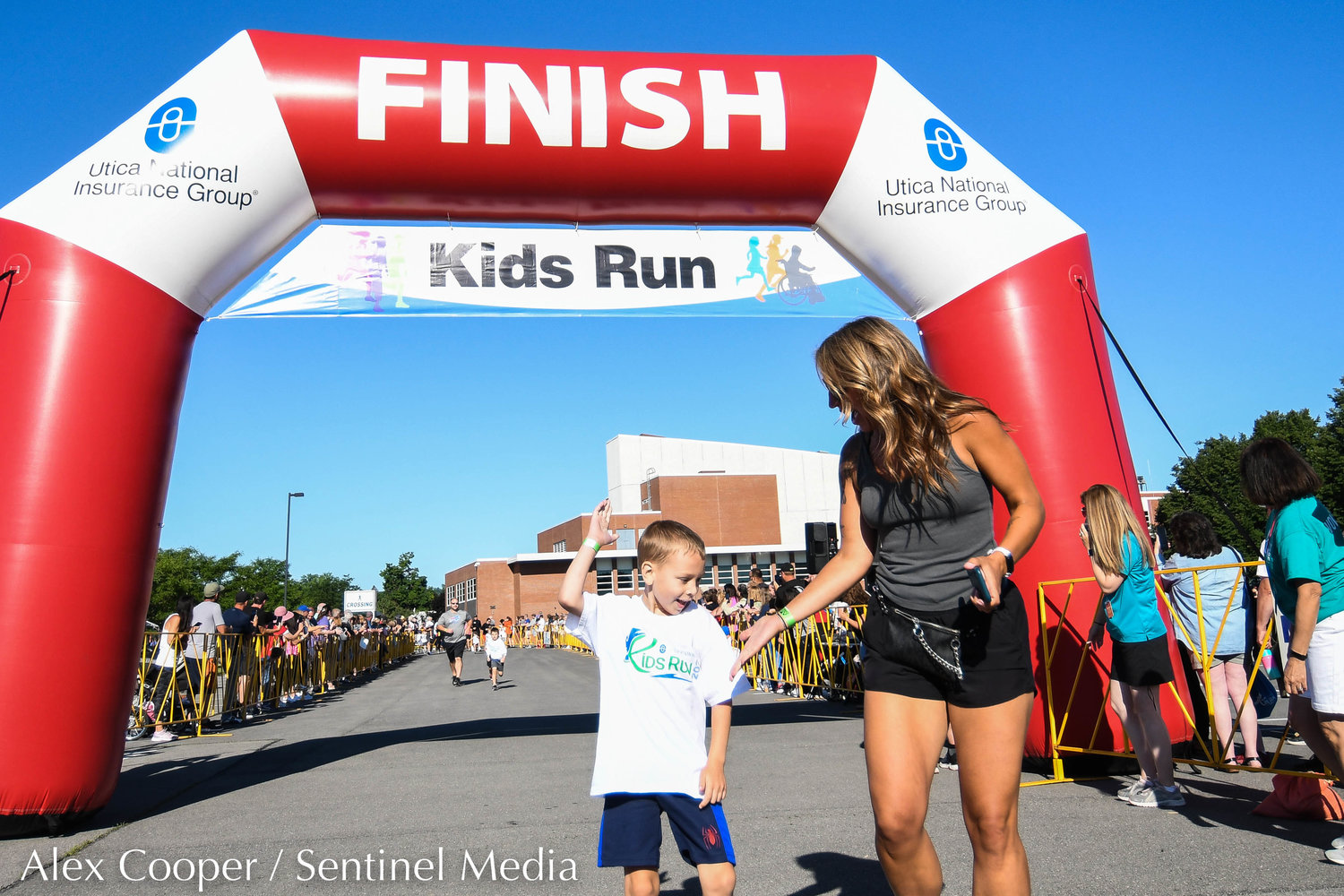 New York Mills resident Erika Fusco congratulates her son Joey after finishing the Utica National Kids Run together at Mohawk Valley Community College in Utica on Saturday.