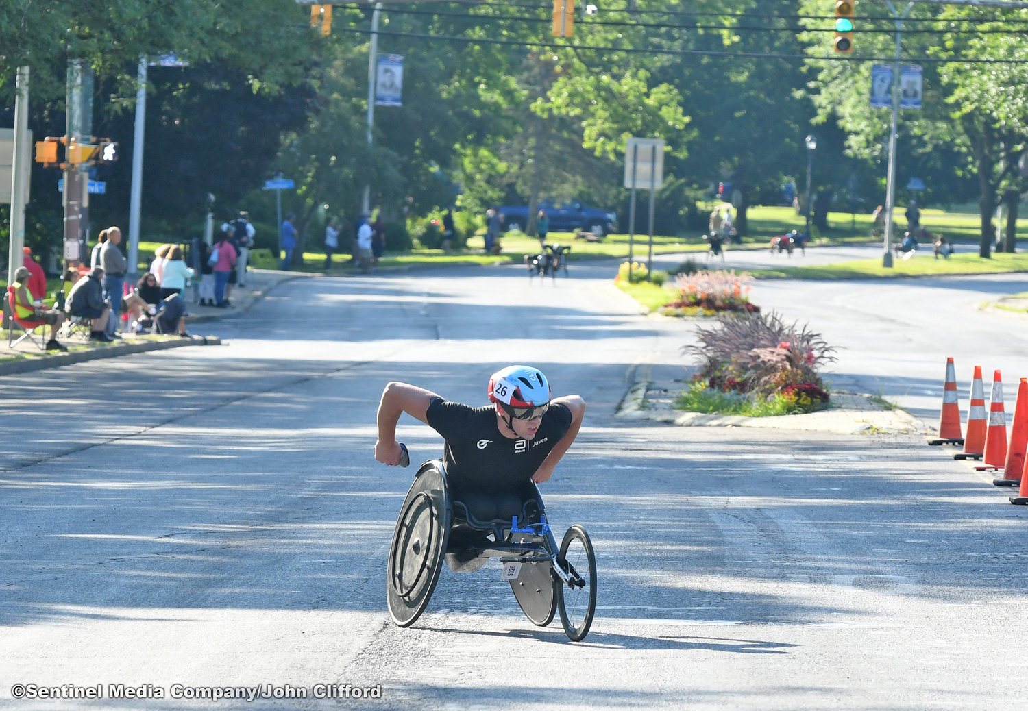 The first wheelchair racer of the 45th Boilermaker Road Race makes the turn left from Memorial Parkway to Valley View Road.