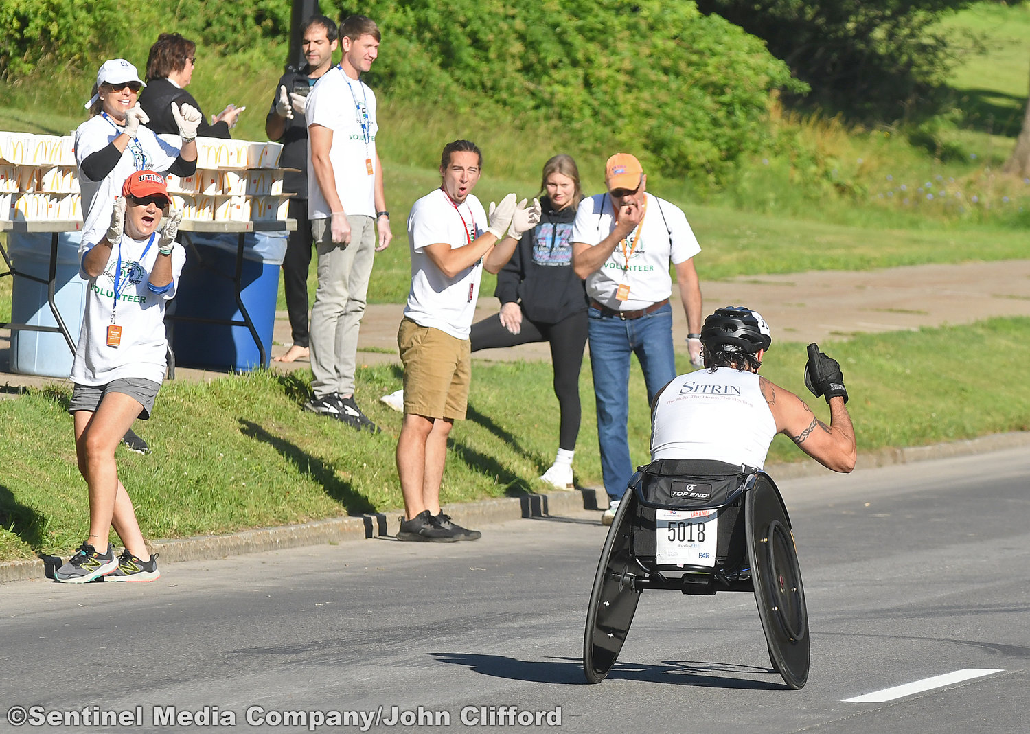 A wheelchair racer James Joseph of New Hartford, NY, is cheered on as he rockets down Memorial Parkway after coming down  Master Garden Road in the 45th Boilermaker Road Race.