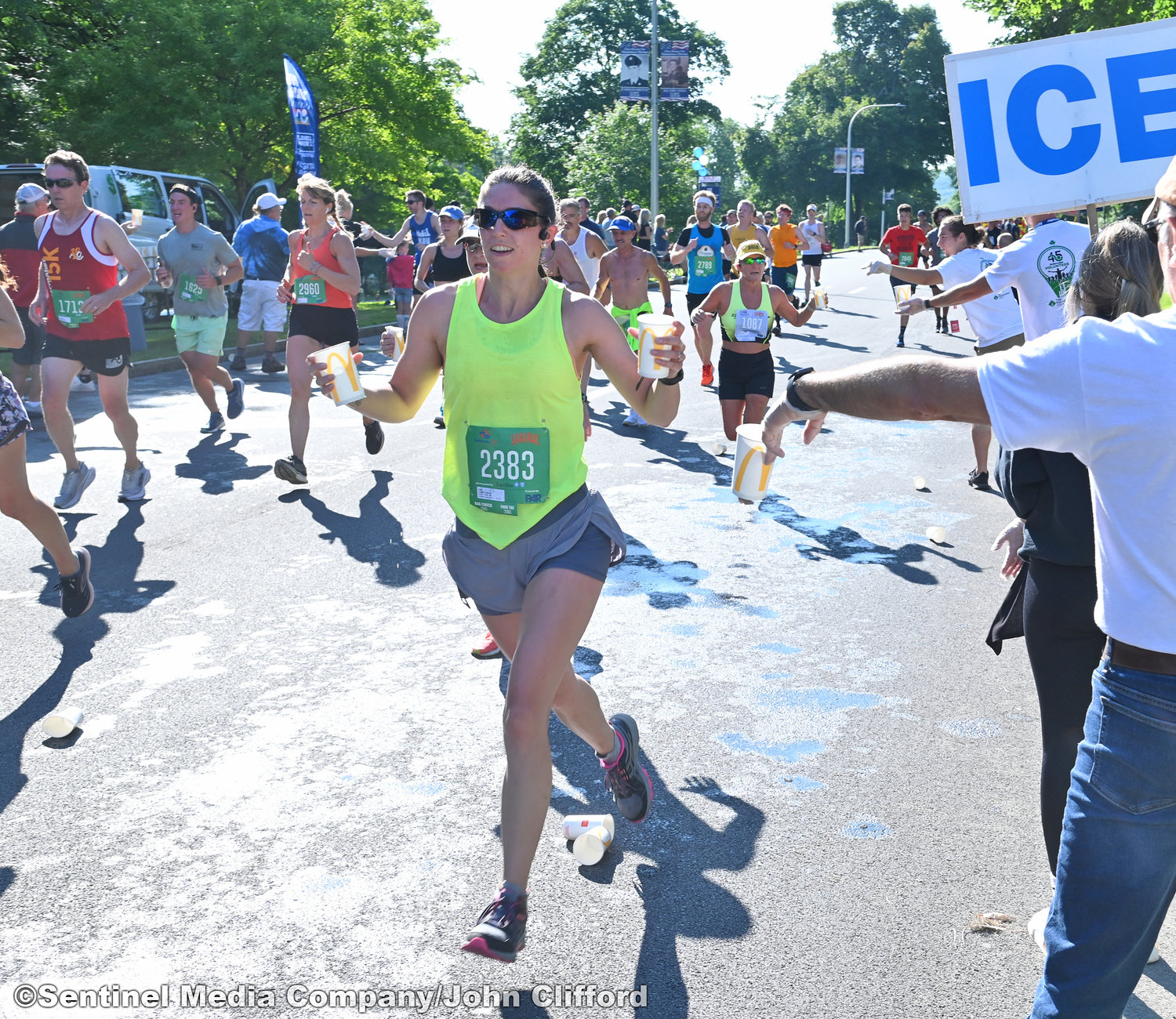A 15k runner dumps water on their head along Memorial Parkway during the 45th Boilermaker Road Race.