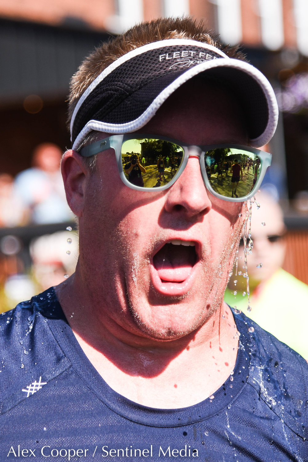 A man dumps water on his head after crossing the finish line during the 45th Boilermaker Road Race on Sunday.