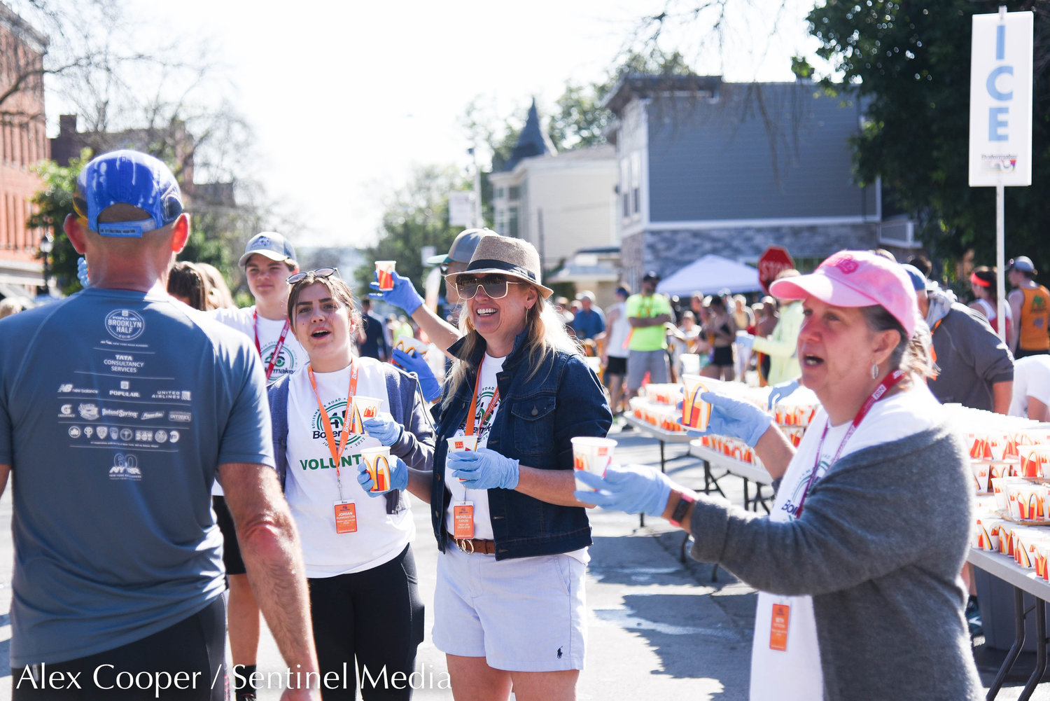 Volunteers hand out water to runners after they cross the finish line during the 45th Boilermaker Road Race on Sunday.