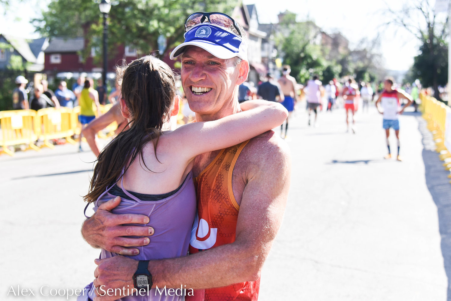 Runners make their way to the Saranac Post Race Party during the 45th Boilermaker Road Race on Sunday.
