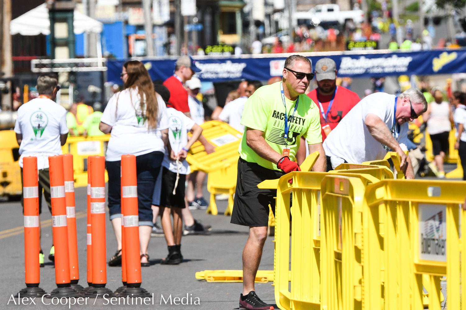 Race safety members break down barriers during the 45th Boilermaker Road Race on Sunday.