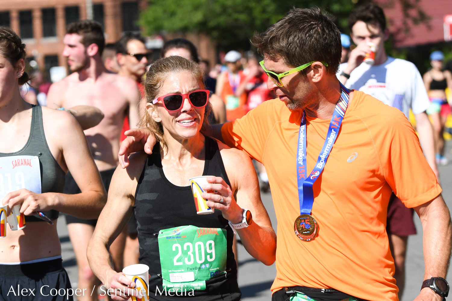 15K runner Aurora Kramer is congratulated moments after crossing the finish line during the 45th Boilermaker Road Race on Sunday.