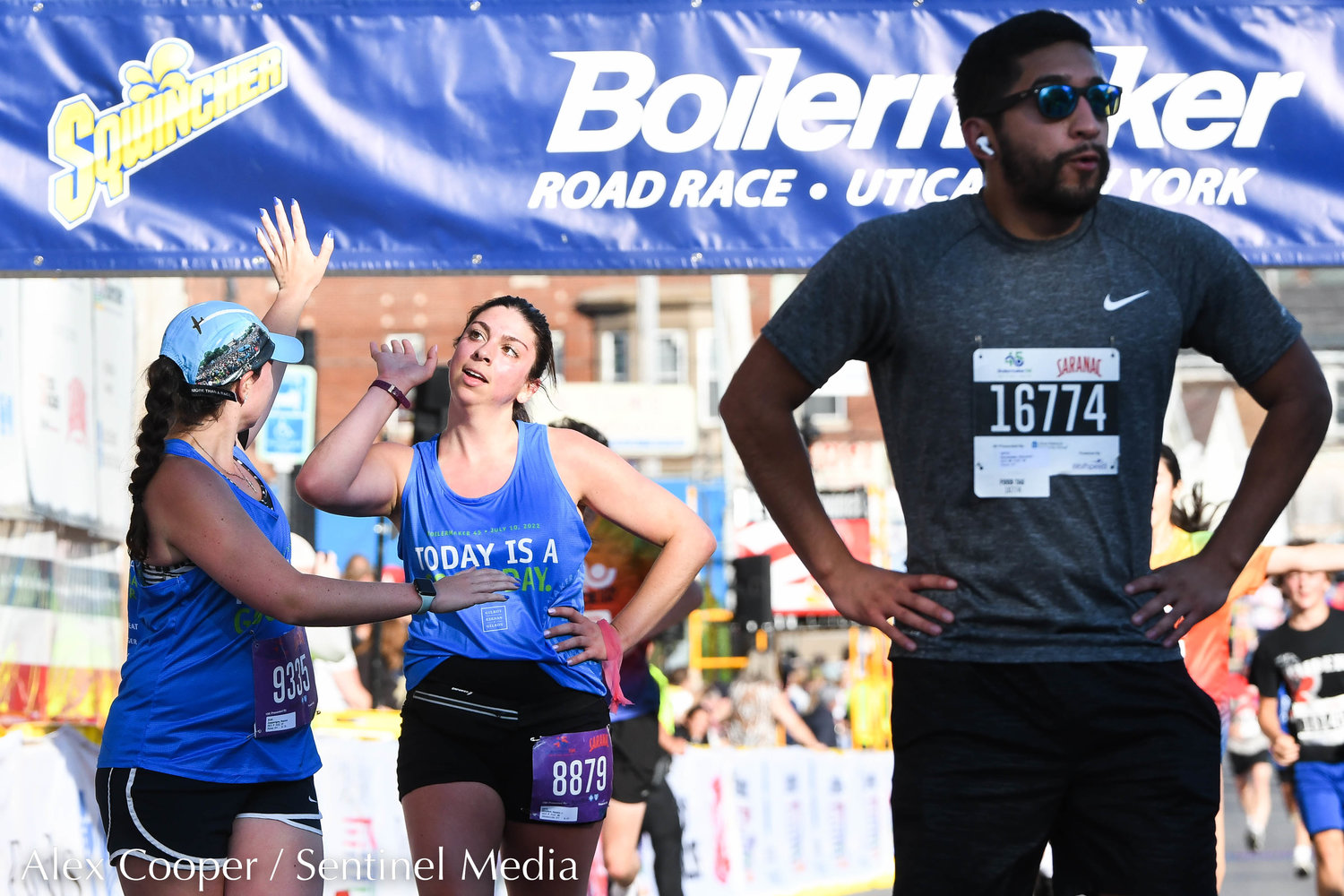 Runners congratulate each other at the finish line during the 5K race at the 45th Boilermaker Road Race on Sunday.