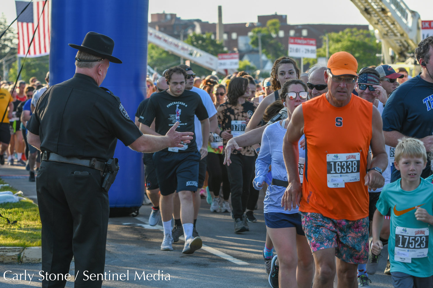 2022 Boilermaker 5K runners reached out to Oneida County Sheriff Robert Maciol as they took off from the starting line on Burrstone Road.