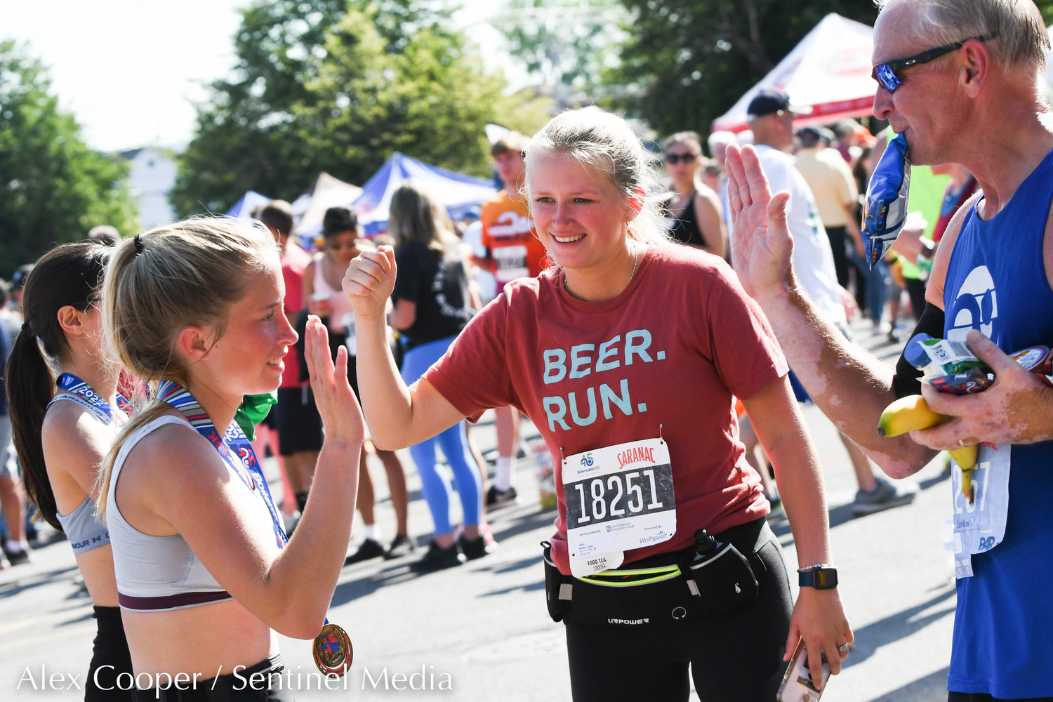 Rome resident Josie Shafer, center, celebrates with friends during the Saranac Post Race Party following the 45th Boilermaker Road Race.