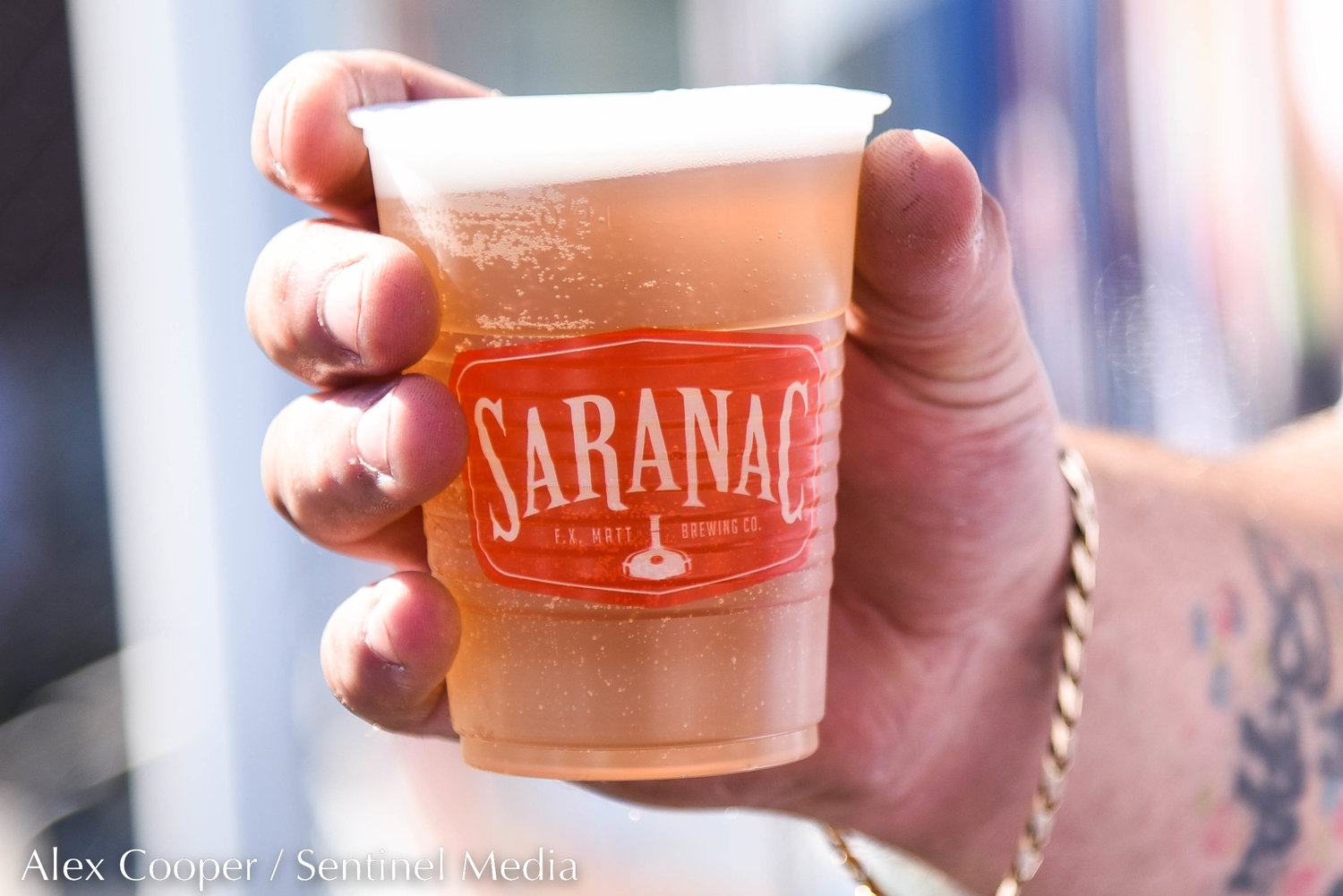 A runner drinks a cold Utica Club at the Saranac Post Race Party following the 45th Boilermaker Road Race in Utica.