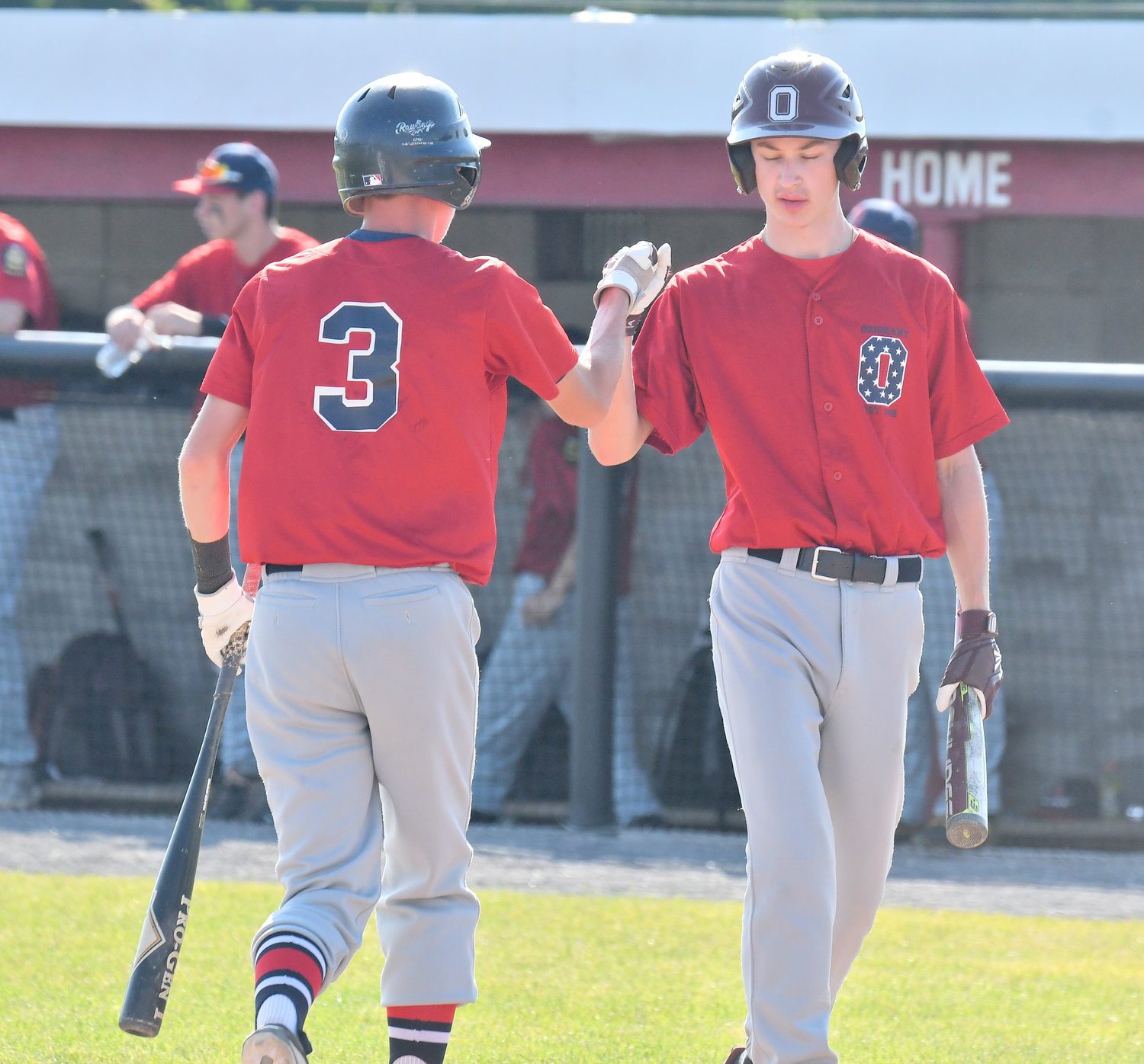 FIRST ROUND WIN — Oriskany Post player Alex Burrows, left, gets congratulations from teammate Joshua Zyskowski after Burrows scored the first run of the District V American Legion playoff game Monday in the team’s 11-1 win over Miller Post of Canastota at DeLutis Field in Rome.