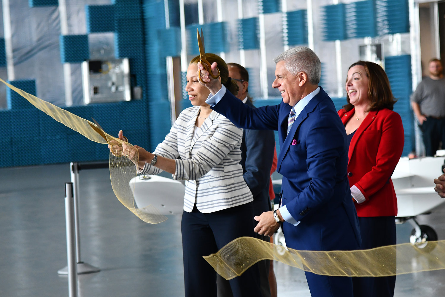 Empire State Development President and CEO and Commissioner Hope Knight, left, and Oneida County Executive Anthony J. Picente, Jr. cut a ribbon at the completion of  Skydome, an indoor UAS testing center in at the Griffiss Business and Technology Park. Behind them are state Sen. Joseph A. Griffo, R-47, Rome, and Griffiss Institute President and CEO Heather Hage.