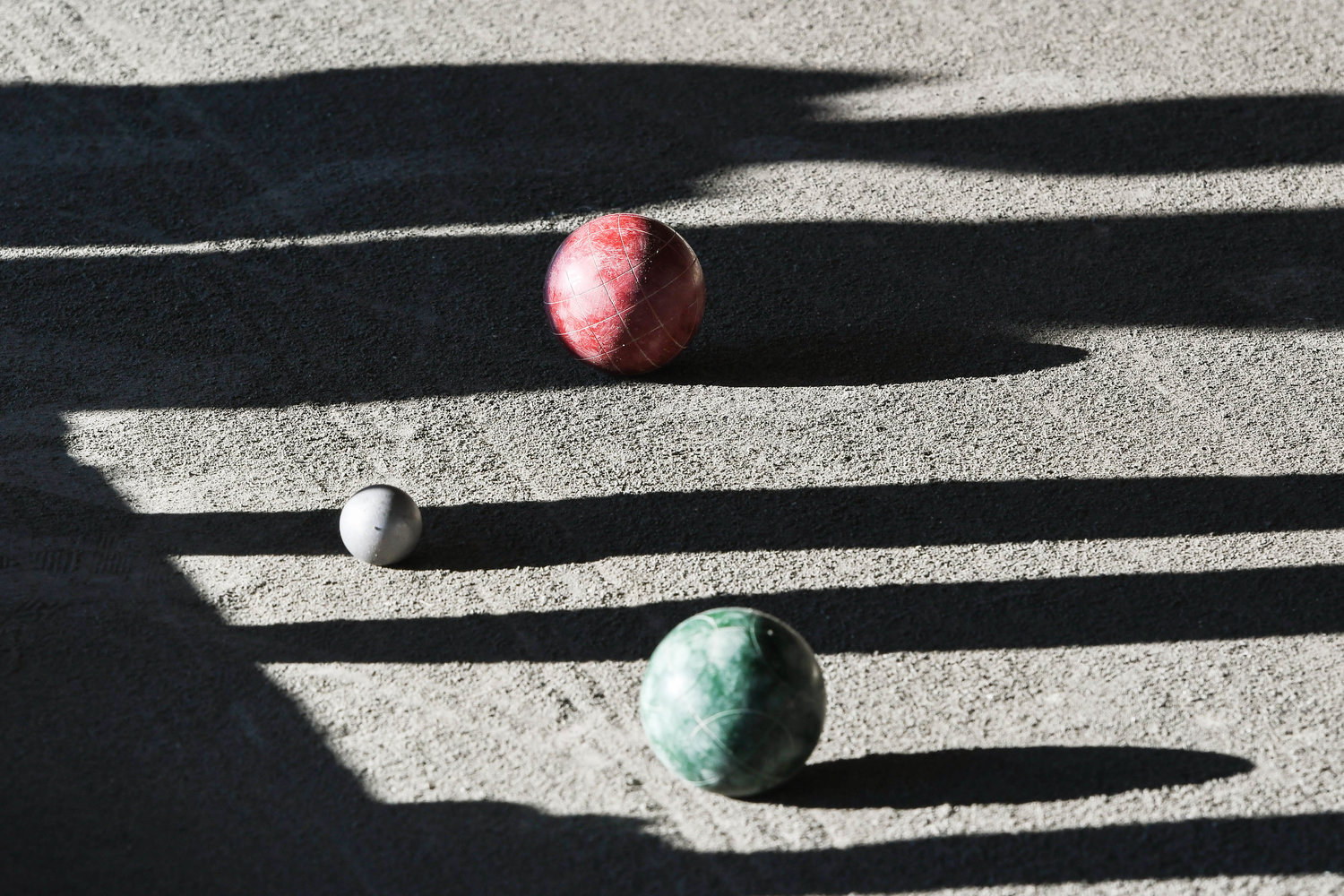 WORLD SERIES — Players cast shadows in the pit during the opening of the womens matches of the World Series of Bocce on Thursday at the Toccolana Club in Rome.