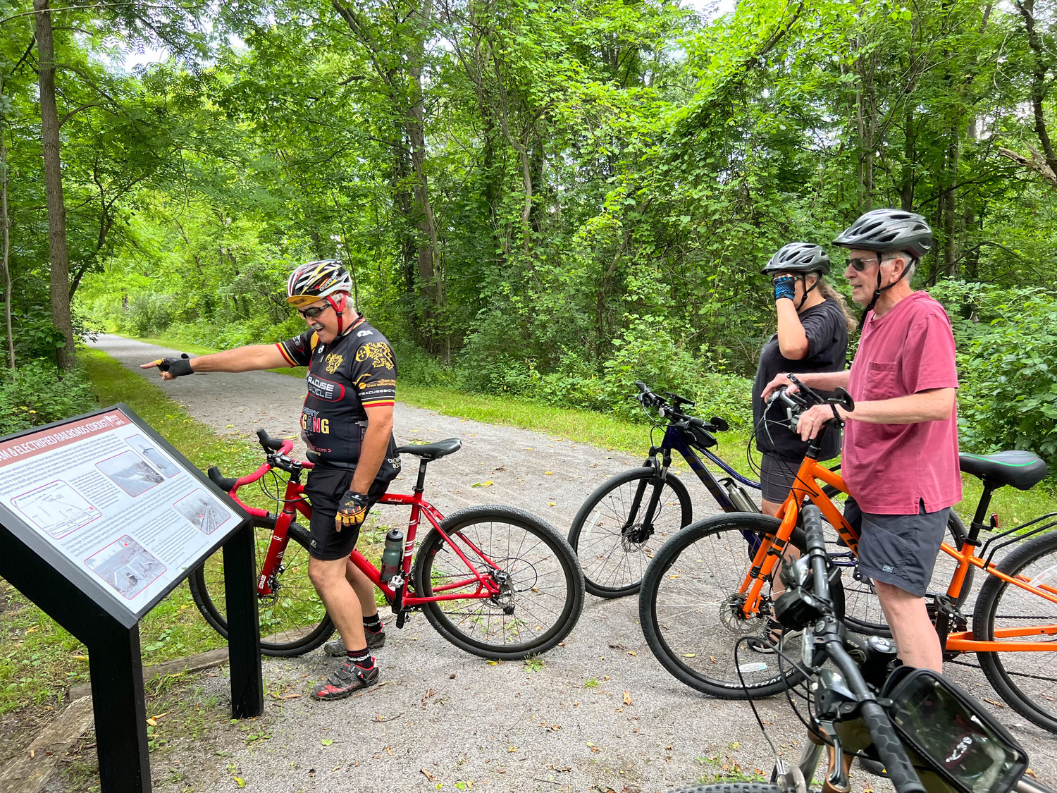 Joe Magliocca (far left) of the Oneida Improvement Committee guides a historic bike tour connecting the Oneida Rail Trail with the Erie Canalway Trail on Tuesday, July 12, 2022.