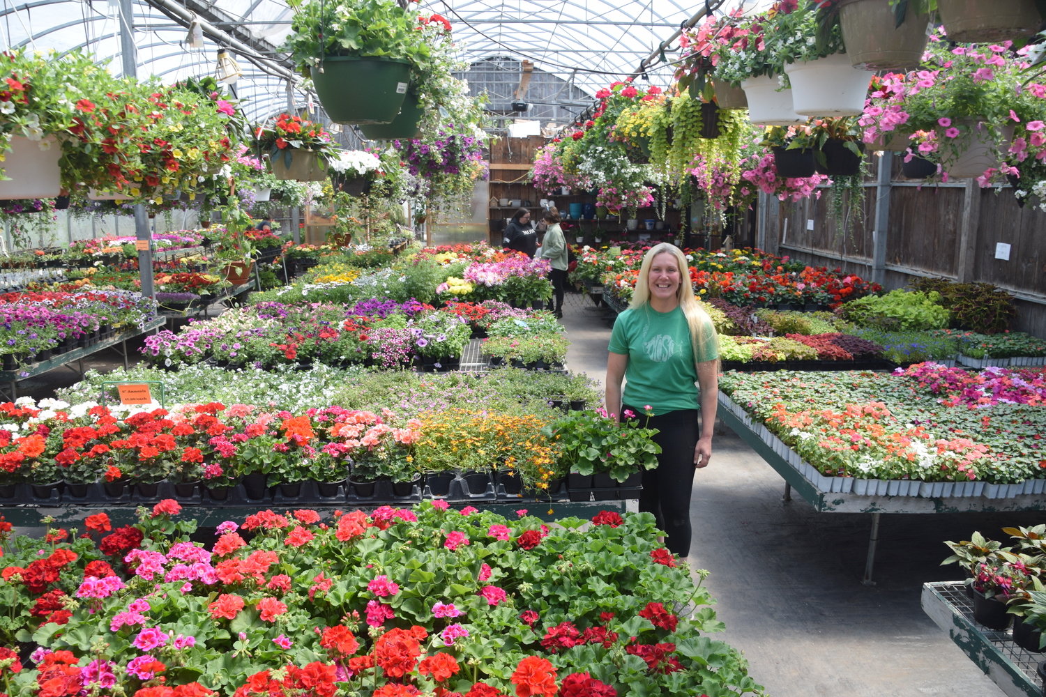 Stephanie Miller stands inside the main greenhouse at Adirondack Greenhouses.