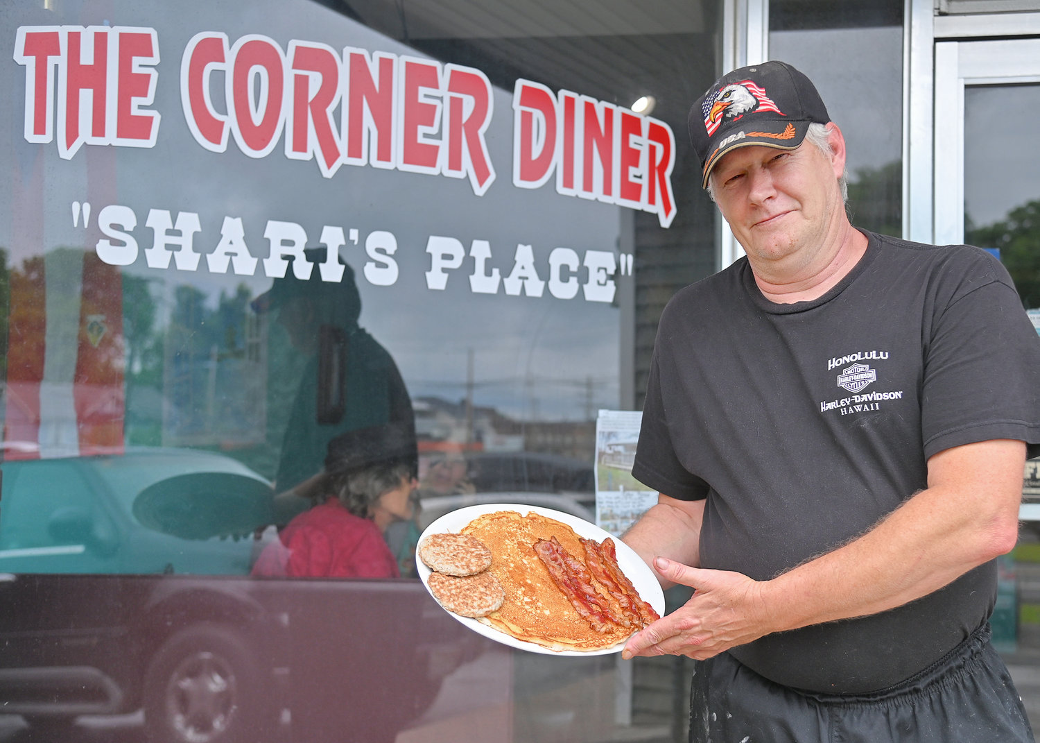 The Corner Diner owner Jon LaBuz with one of his signature breakfast items “The Hubcap” pancake.