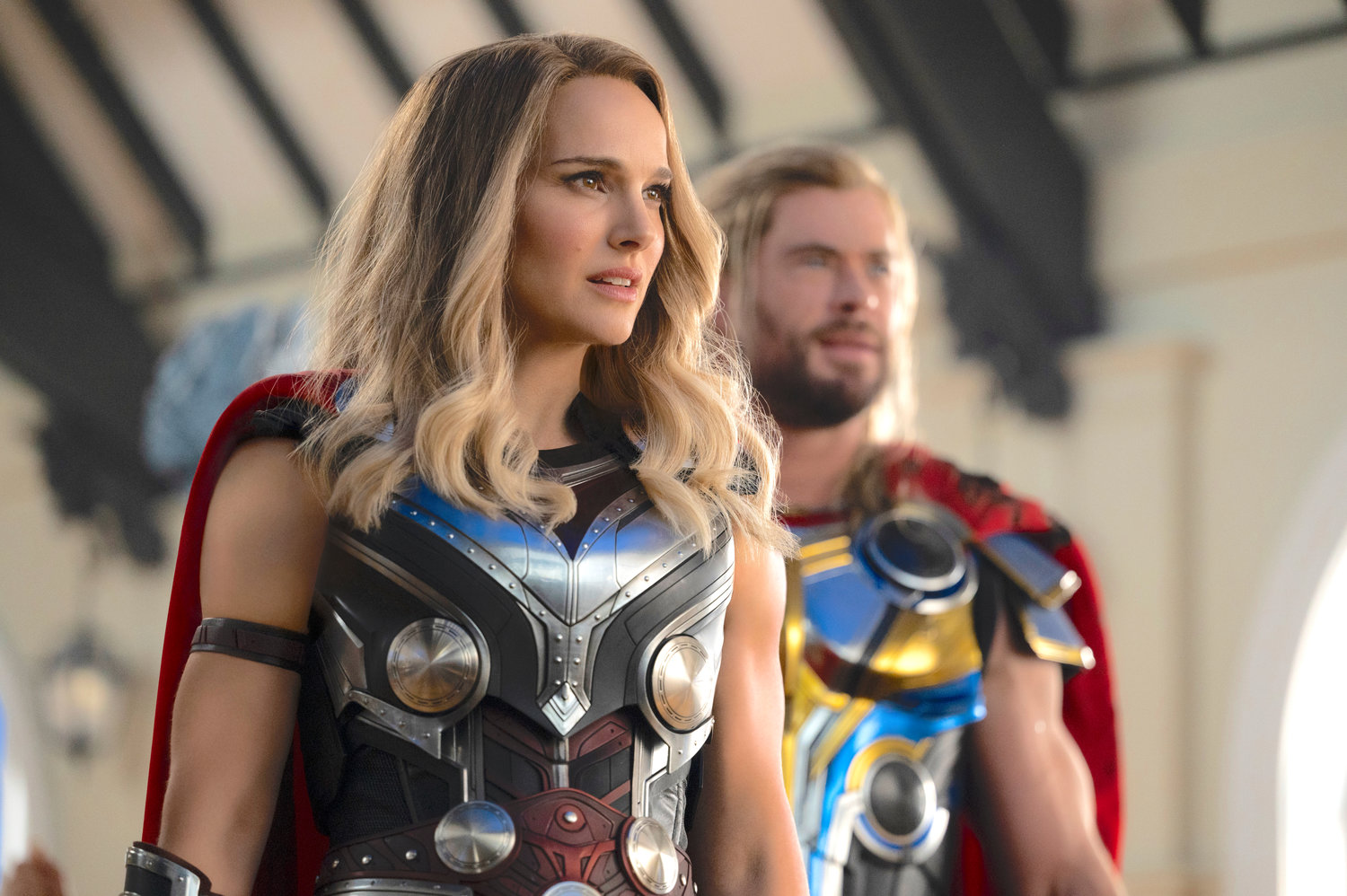 Natalie Portman, left, and Chris Hemsworth in a scene from “Thor: Love and Thunder.”