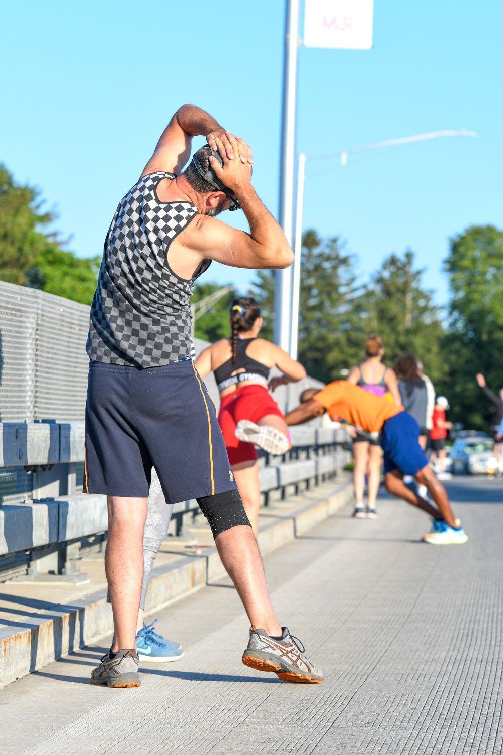 Burrstone Road bridge made for the perfect stretching arena before the 2022 Boilermaker 5K. Many who spoke with the Sentinel didn't describe themselves as athletes — they were just there to have a good time.
