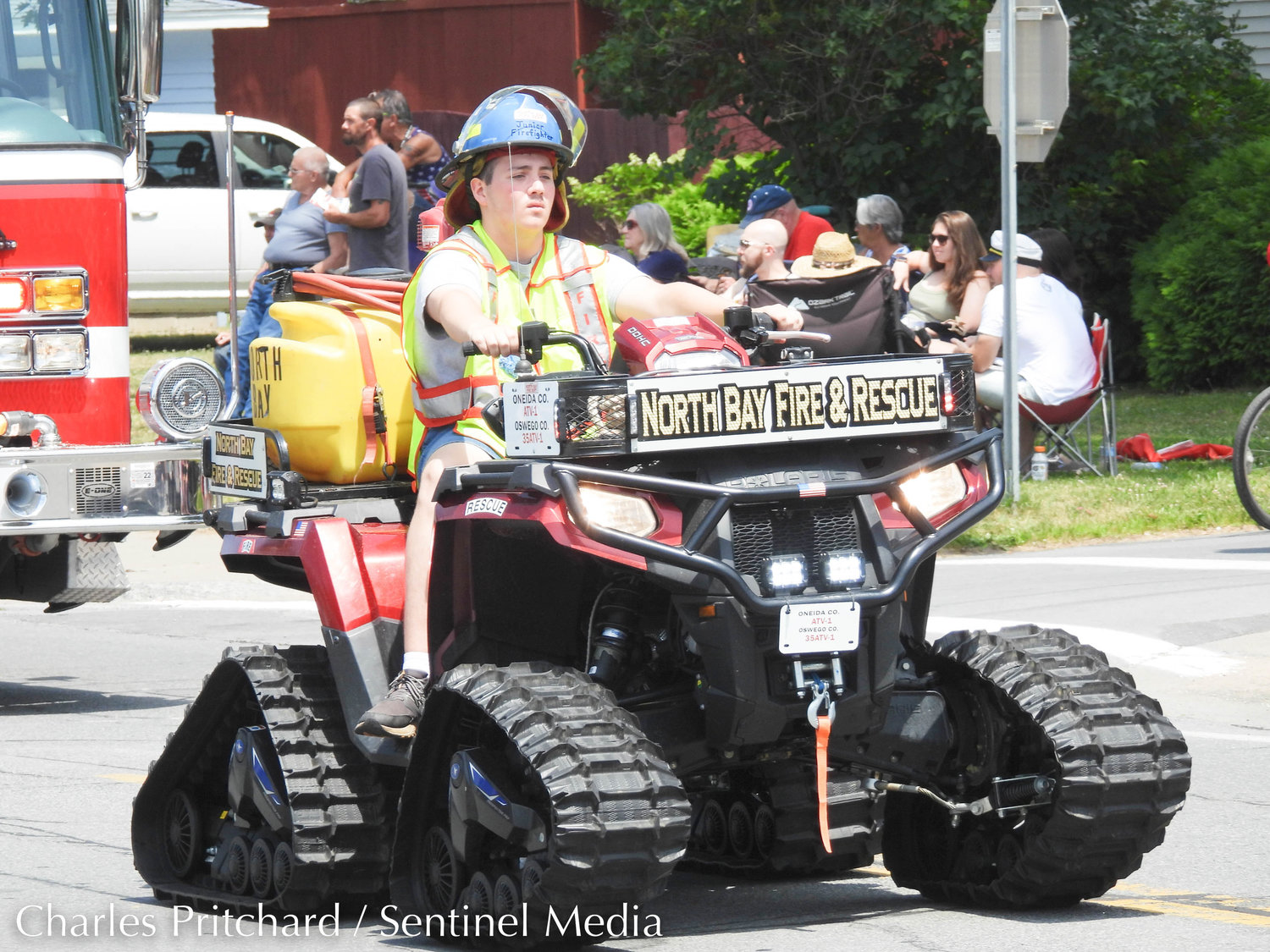 The Sylvan Beach Pirate's Parade makes its way down Main Street. Pictured is a North Bay Fire Department junior fire fighter, riding one of the department's ATVs equipped with side-by-side tracks.