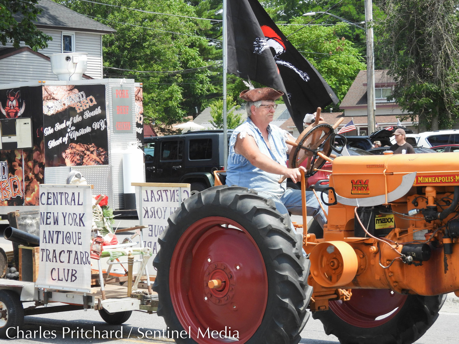 The Sylvan Beach Pirate's Parade makes its way down Main Street. Pictured is the Central New York Antique "TractARR" Club, with tractors outfitted to resemble pirate ships.