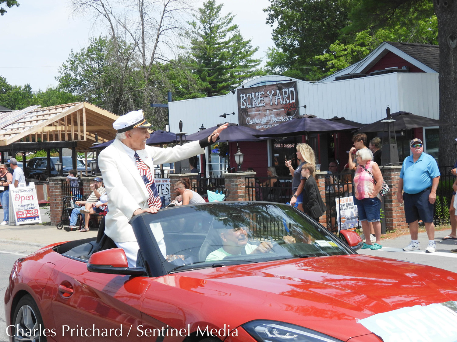 The Sylvan Beach Pirate's Parade makes its way down Main Street. Pictured is Sylvan Beach's own Captain John, waving to attendees of the parade.
