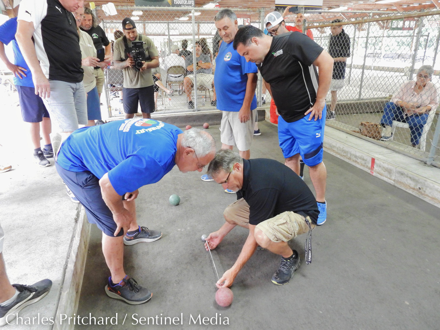 Finalists Tri-State Bocce and Club Vitu Lazio compete in the open division of the 47th World Series of Bocce Sunday at sun-drenched Toccolana Club in Rome. Pictured are World Series of Bocce officials Bernie Colangelo, left, and Todd Lanzi as they preform a measurement.