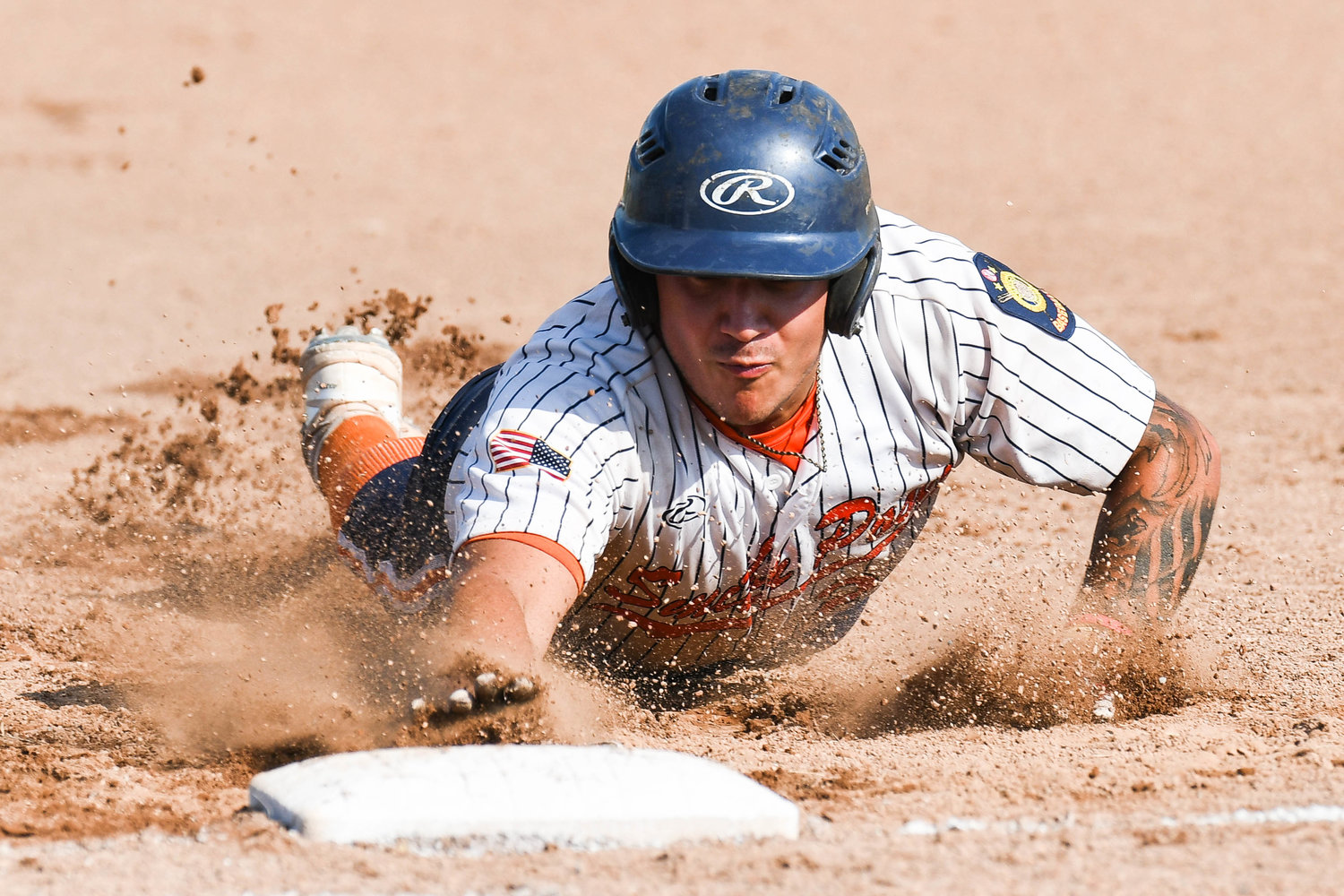 Smith Post baserunner Damon Campanaro slides safely back into first base during the District V American Legion championship game against Whitestown Post on Tuesday at DeLutis Field in Rome. Whitestown won 1-0 in eight innings.