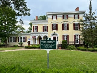 An historical sign relays the history of the home of the Alexander Hamilton Institute in Clinton.