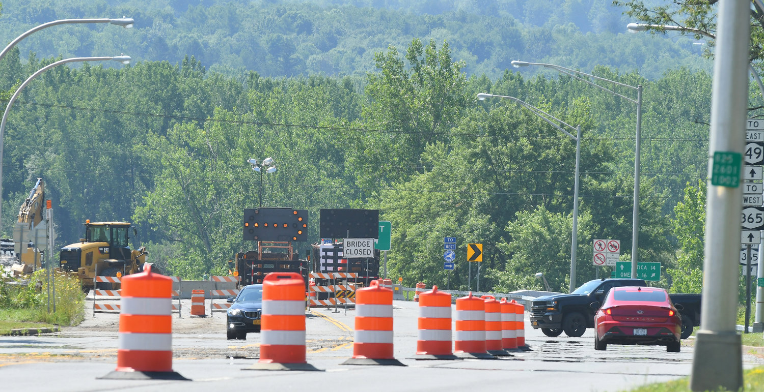 NAVIGATING THE CONSTRUCTION — Cars work their way toward detours as the busy bridge leading to and from the Griffiss Business and Technology and Route 49 which closed late Monday for construction. Motorists are advised to follow detour signs to make their way around the construction which is expected to be complete in September.