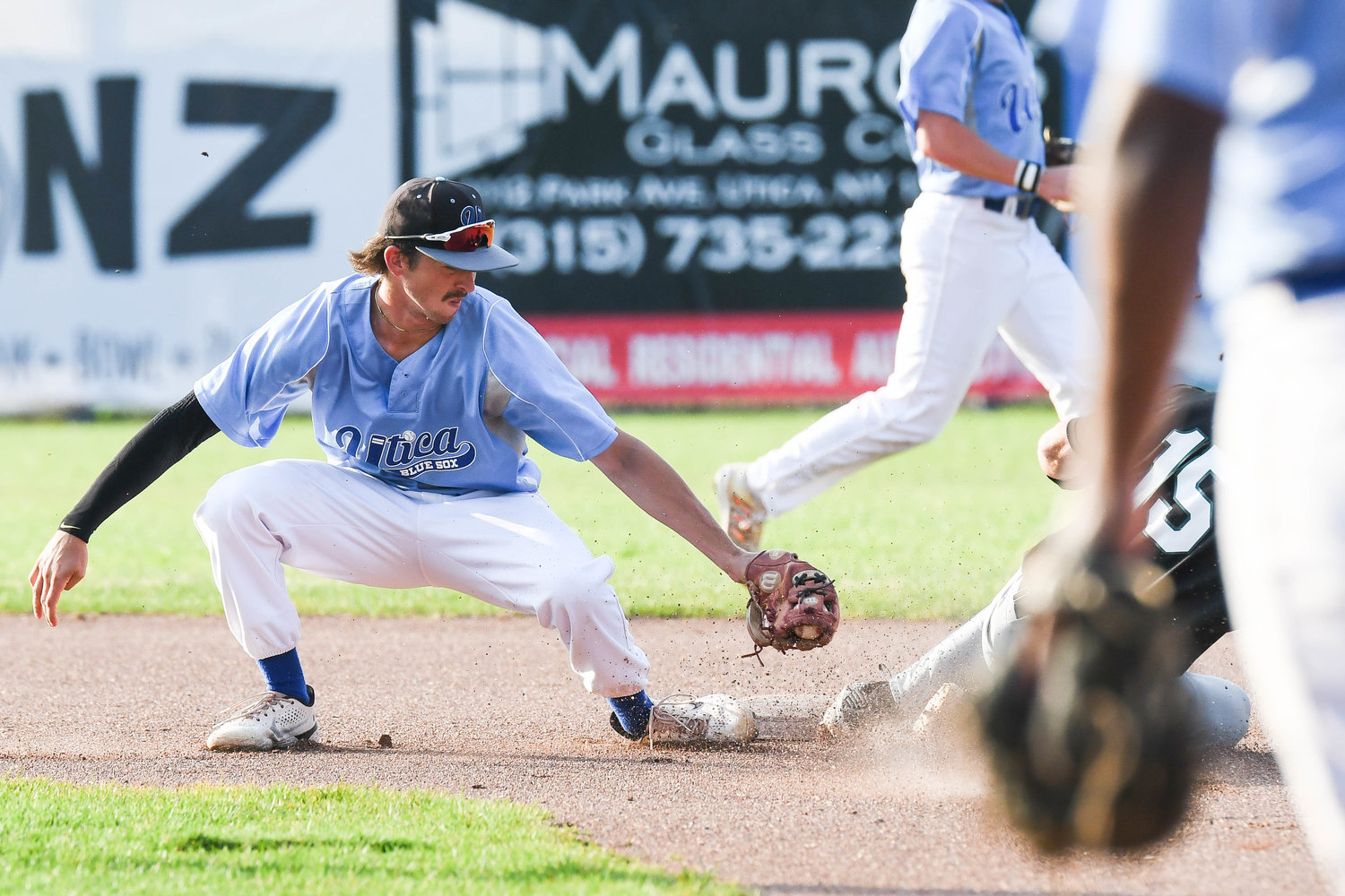 Utica Blue Sox player Troy Hamilton attempts to tag out Mohawk Valley DiamondDawgs base runner Pete Durocher during the game on Wednesday night at Donovan Stadium at Murnane Field in Utica.