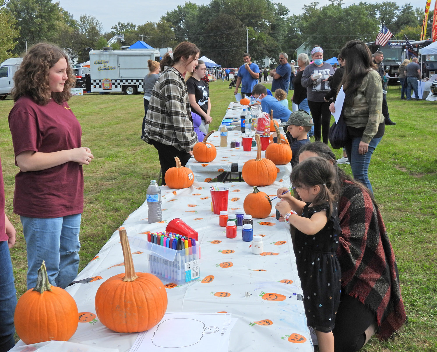 Children paint pictures on their pumpkins at last year's Fall Fest in Oneida.
