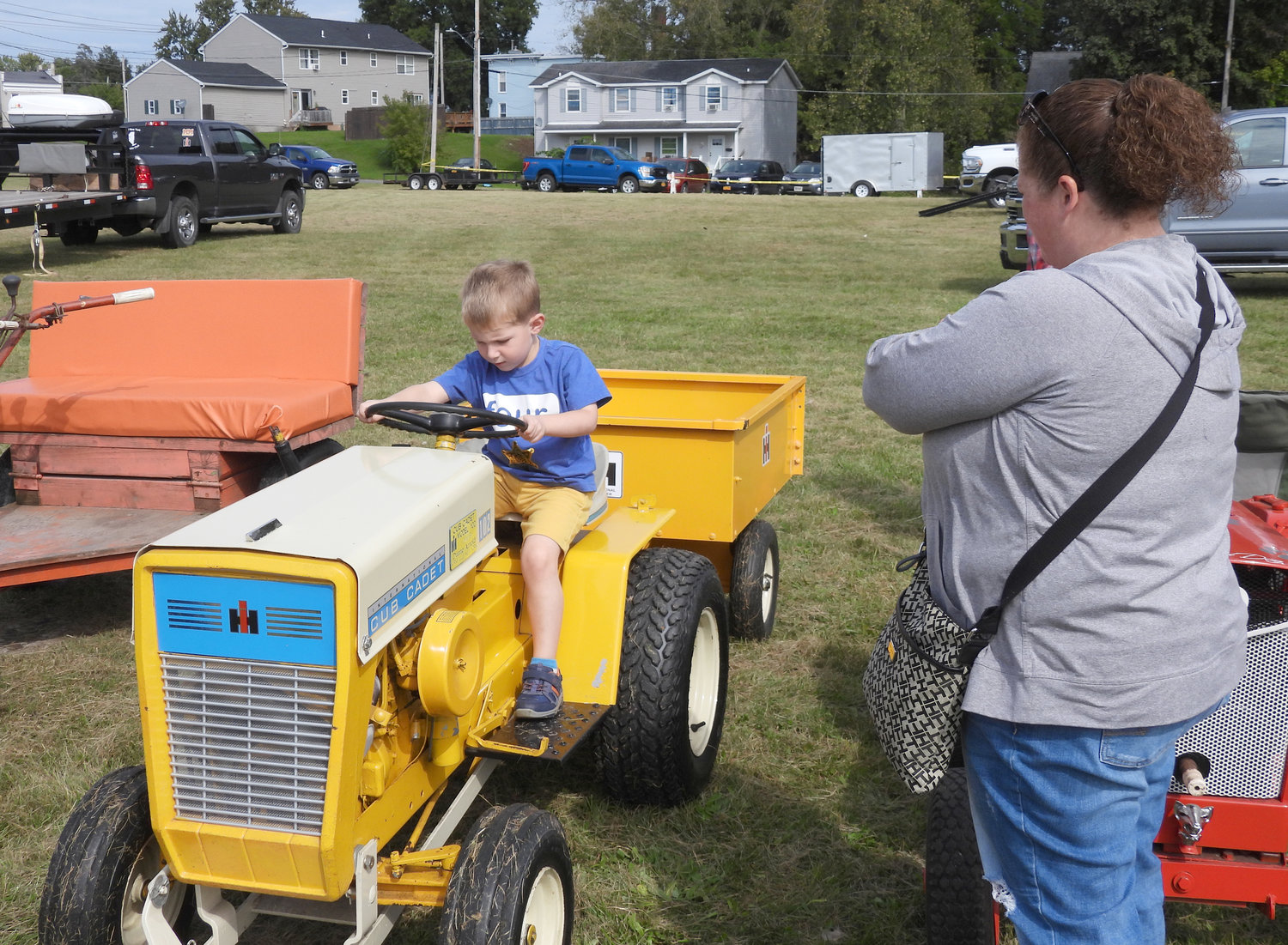 Chittenango resident Trish Leonard watches her nephew Grant Lois have fun on an old-fashioned tractor at last year's Fall Fest in Oneida.