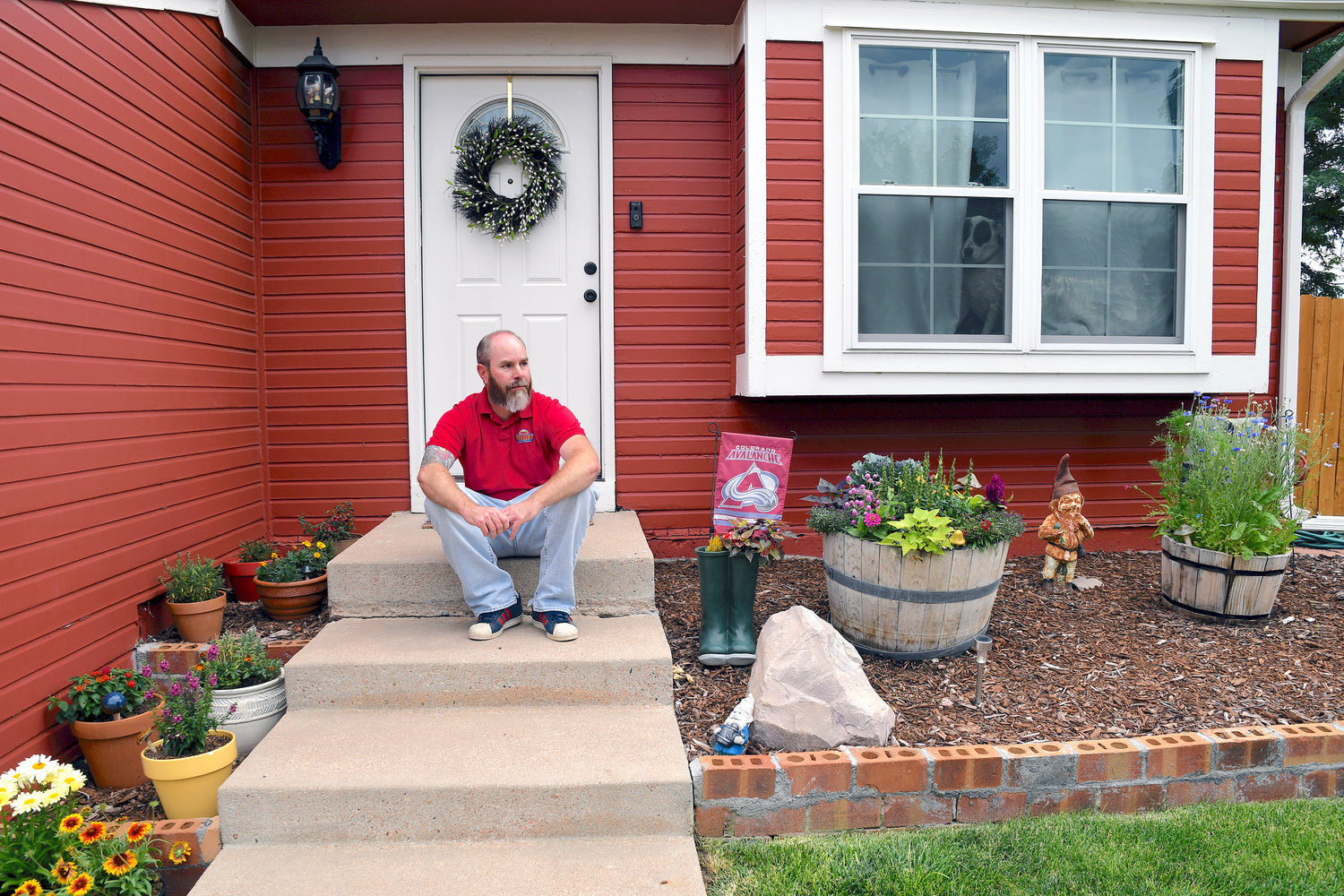 Kyle Tomcak sits in front of his house in Aurora, Colo., on July 18. Tomcak was in the market for a home priced around $450,000 for his in-laws and he and his wife bid on every house they toured. He said his search became increasingly dispiriting as he not only lost out to investors fronting cash offers $100,000 over asking price but as mortgage rates started to balloon. He has since pulled out of the housing search.