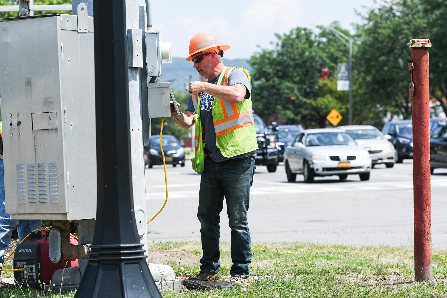 A Department of Transportation worker plugs in a generator to fix a traffic light on the corner of North Genesee Street. and Wurz Avenue in Utica after a power outage on Friday shut down several street lights. National Grid said nearly 600 customers were without power for about an hour.