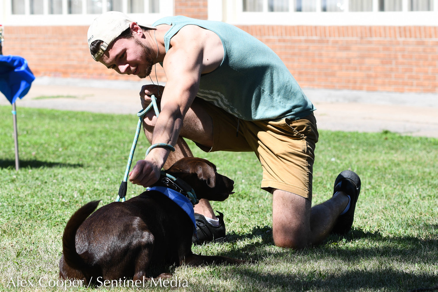 Austin Green helps his chocolate lab Amaretto do a trick during a dog show hosted by the Herkimer County Humane Society on Saturday at Central Plaza in Ilion. The show was part of a long list of events hosted during Ilion Days 2022 from July 16-24.