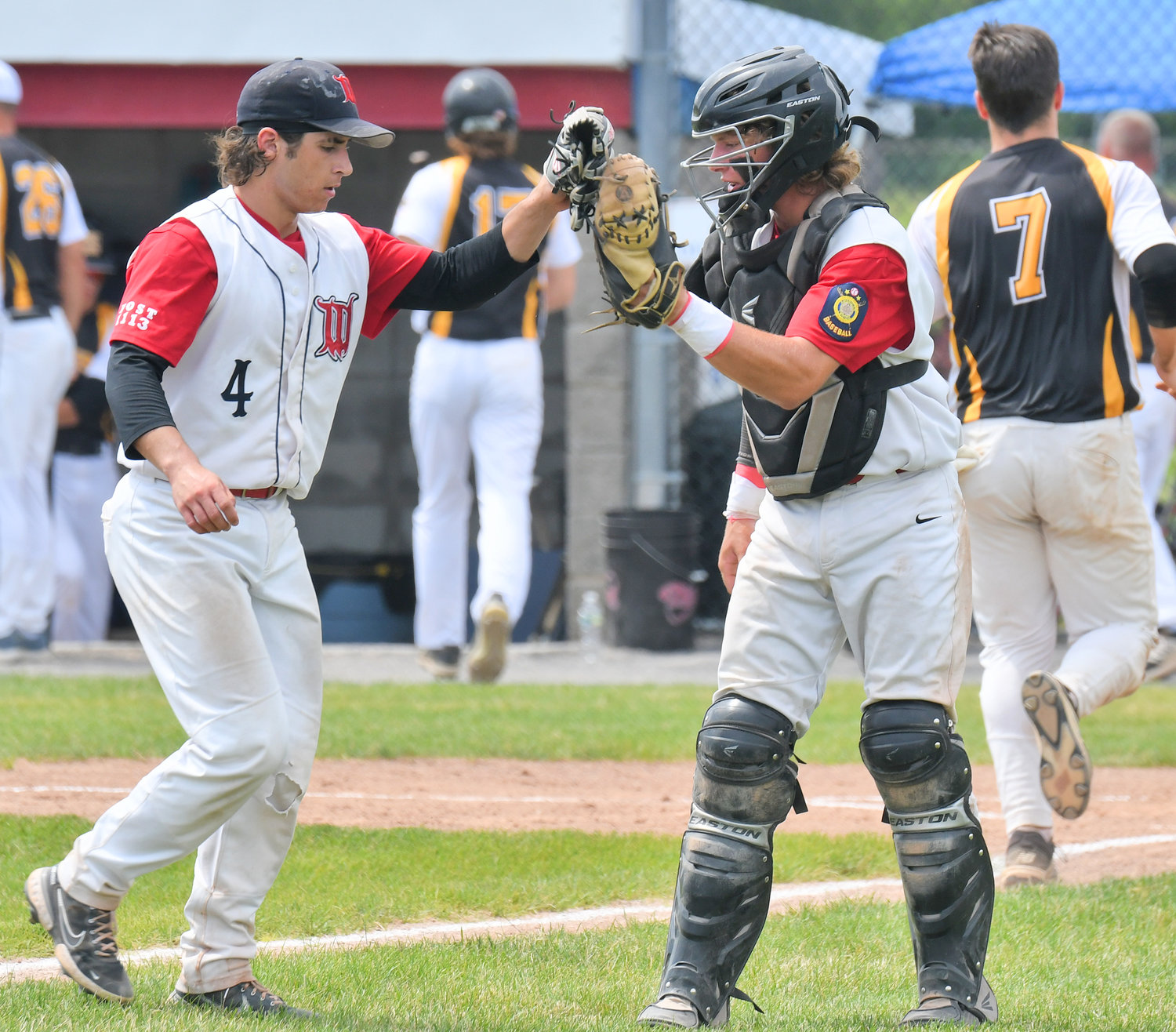 Whitestown Post's Caleb Miller, left, and catcher Jerry Fiorini celebrate after the team retired Harpursville Post in the second inning of an American Legion tournament game Saturday at DeLutis Field in Rome. Miller pitched six innings to help Whitestown earn a 4-3 win. The team is scheduled to play at 10 a.m. Tuesday in Saugerties.
