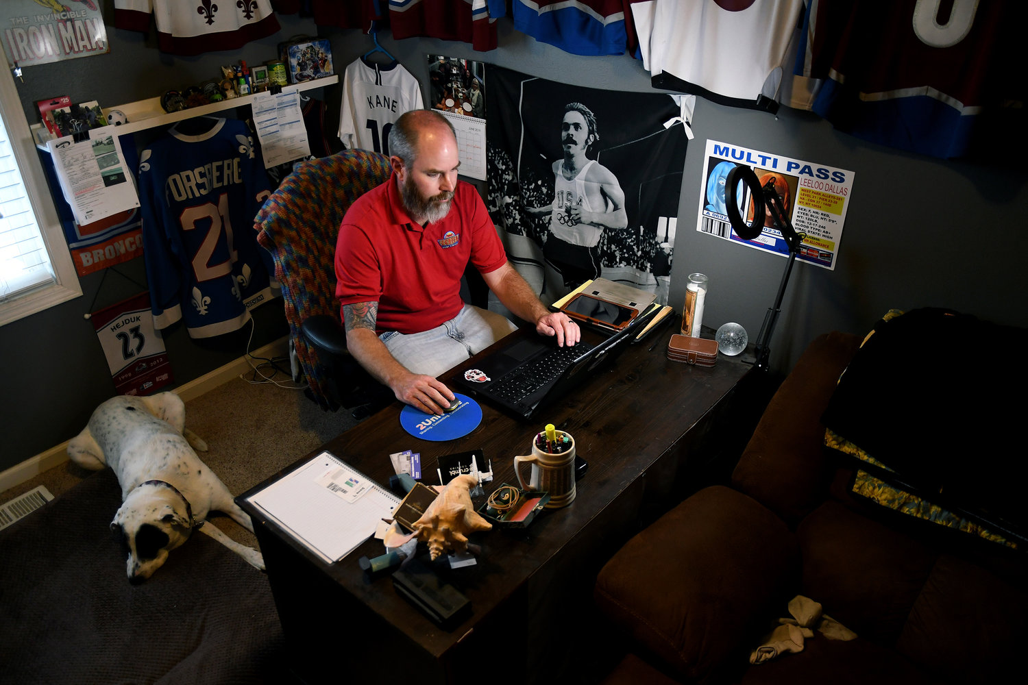 Kyle Tomcak works in his home office in Aurora, Colo., on Monday, July 18, 2022. Tomcak was in the market for a home priced around $450,000 for his in-laws and he and his wife bid on every house they toured, regardless of whether they fell in love with the home. He said his search became increasingly dispiriting as he not only lost out to investors fronting cash offers $100,000 over asking price but as mortgage rates started to balloon. He has since pulled out of the housing search. (AP Photo/Thomas Peipert)