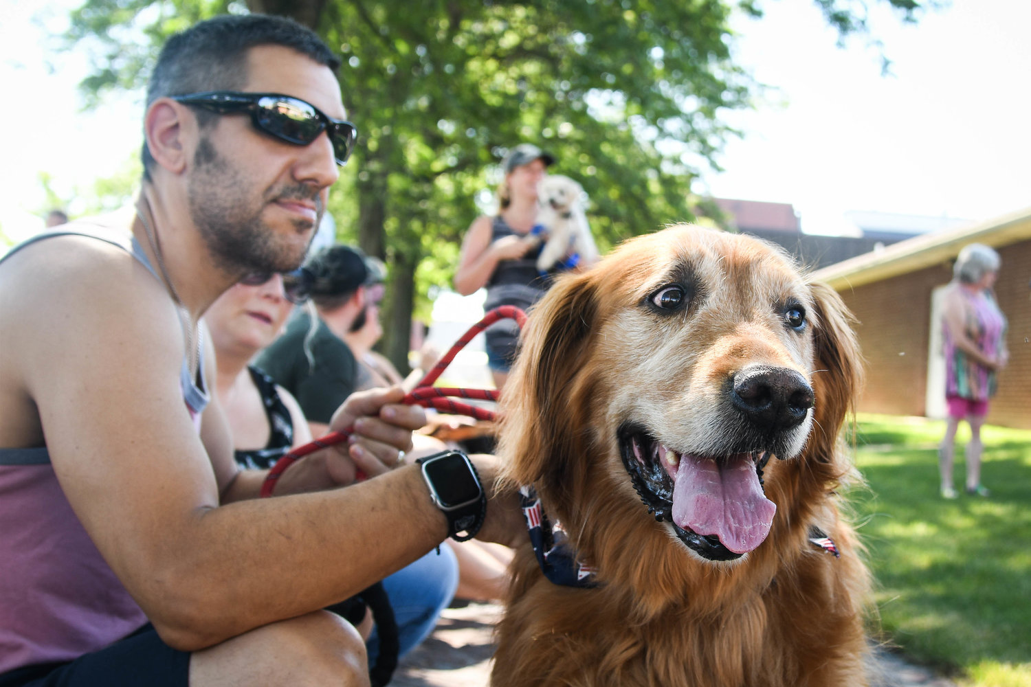 NOT SO RUFF — Buddy, a golden retreiver, sits patiently with his owner, Ryan, during a dog show hosted by the Herkimer County Humane Society on Saturday at Central Plaza in Ilion. The show was part of a long list of events hosted during Ilion Days 2022 last week.