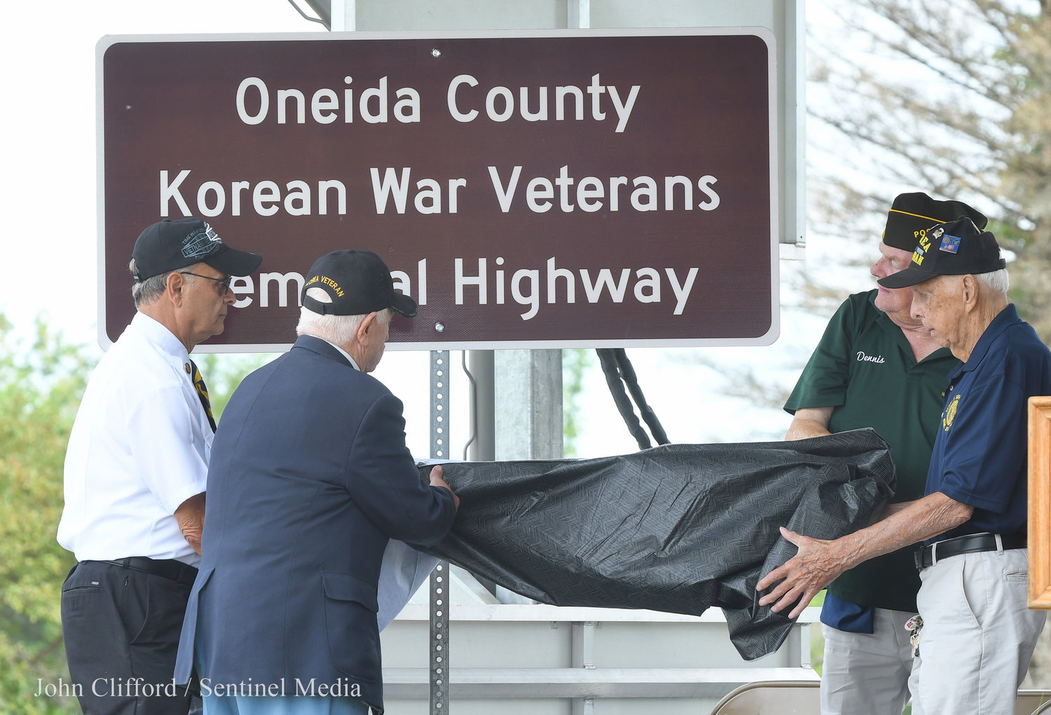 Pictured is the unveiling of the highway marker dedicating State Route 365 as the Oneida County Korean War Veterans Memorial Highway.