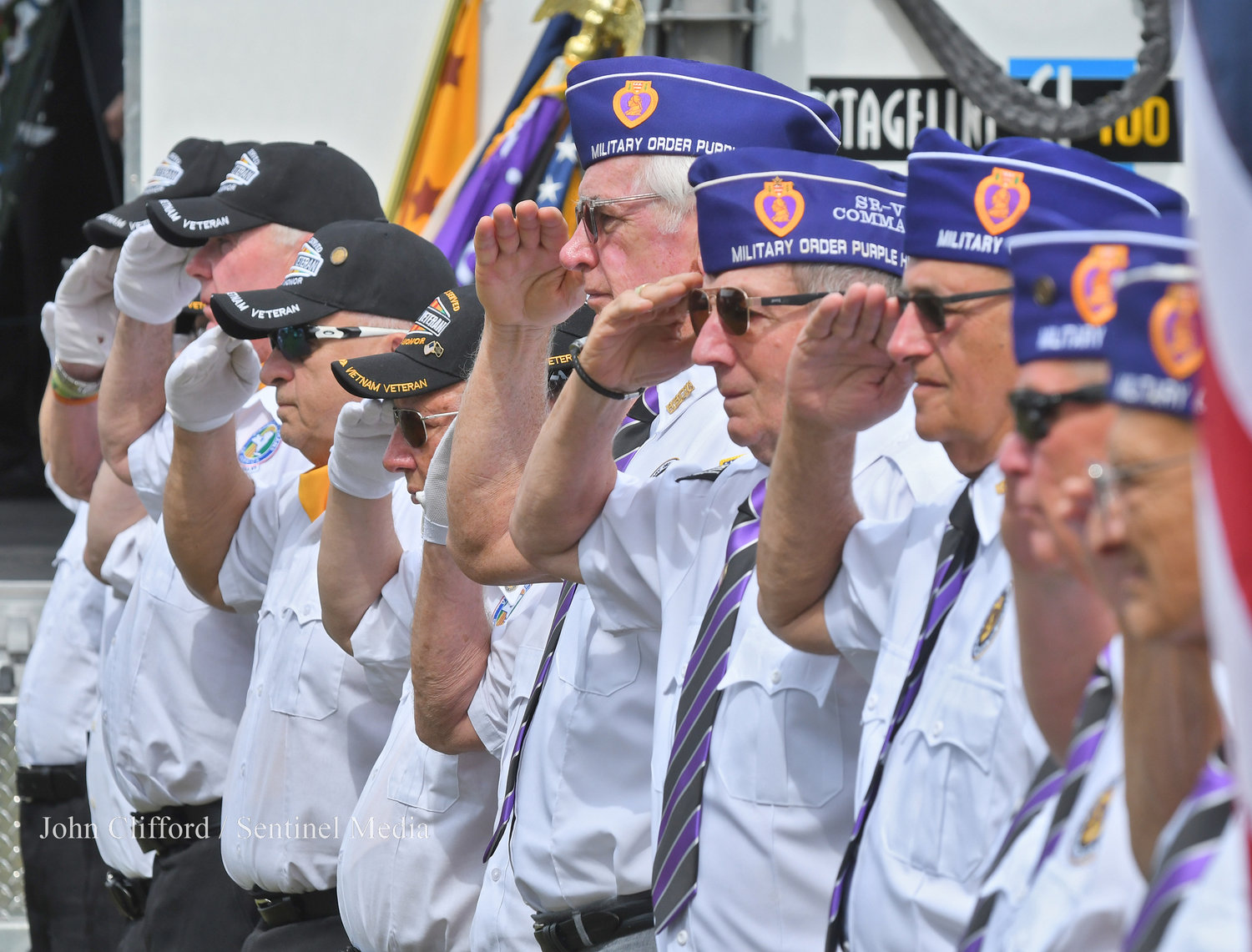 Vietnam Veterans of America and Military Order of the Purple Heart salute during the ceremony during taps.