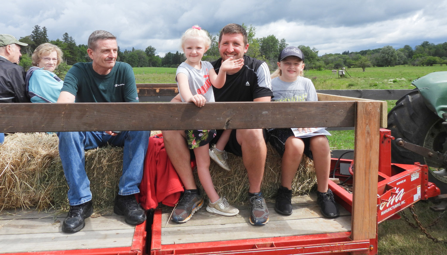 A little girl waves during a tractor ride at Albanese Longhorns in Cazenovia. Open Farm Day on Saturday, July 30 saw people from all over visiting their local farms and seeing firsthand what they offer to the community.