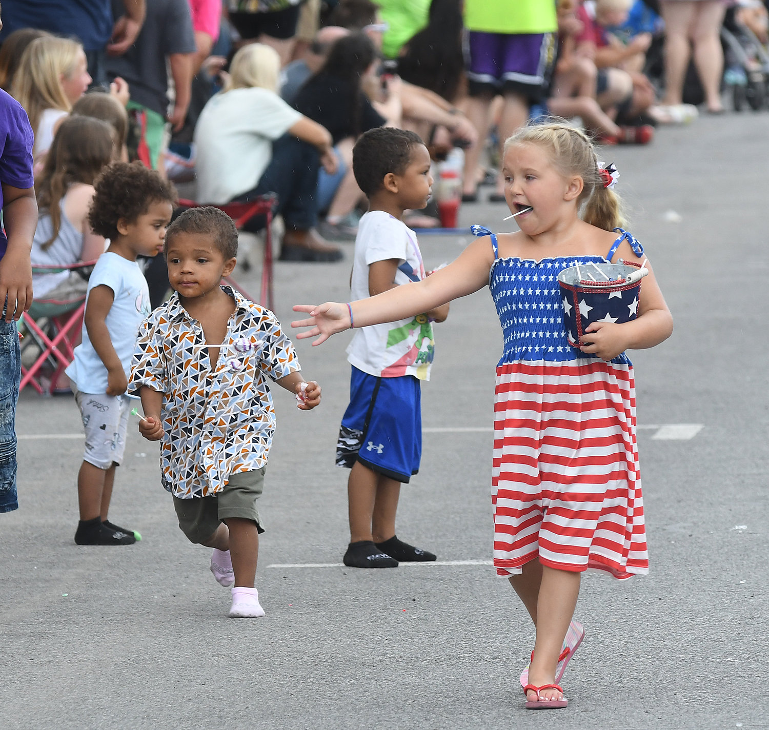 Honor America Days parade participant Carly O’Brien, 8, hands out candy out along the parade route Saturday.