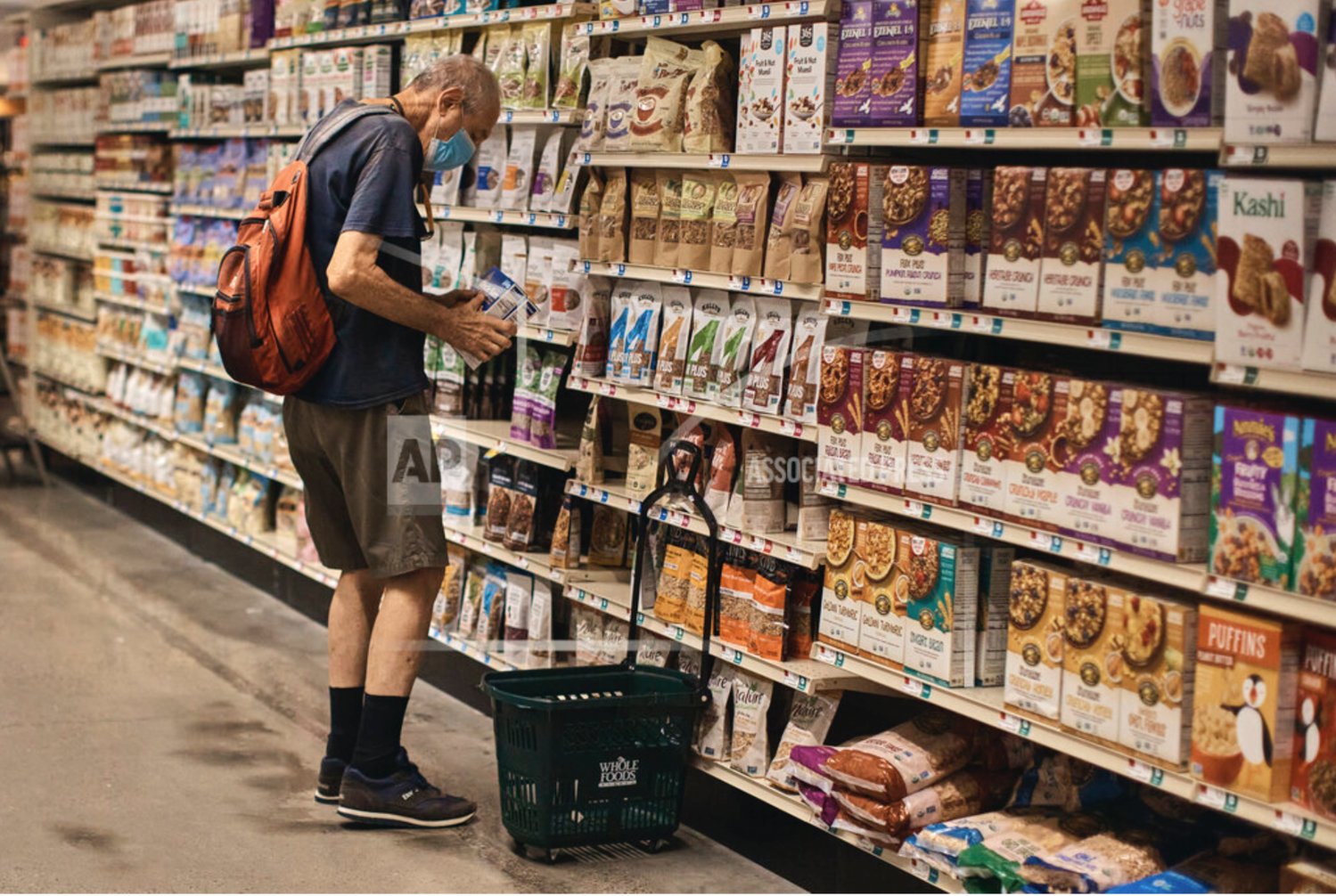 A man shops at a supermarket on Wednesday, July 27, 2022, in New York. The U.S. economy shrank from April through June for a second straight quarter, contracting at a 0.9% annual pace. The move has many consumers taking steps to cut costs amid concerns over their personal finances.