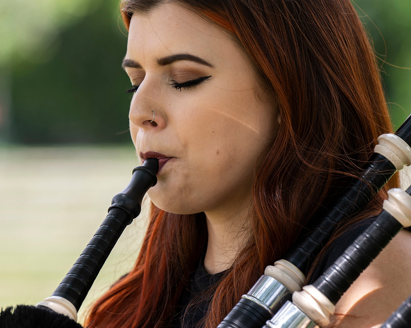 Ally the Piper plays the bag pipes in Collins Park in Scotia Wednesday, July 13, 2022.