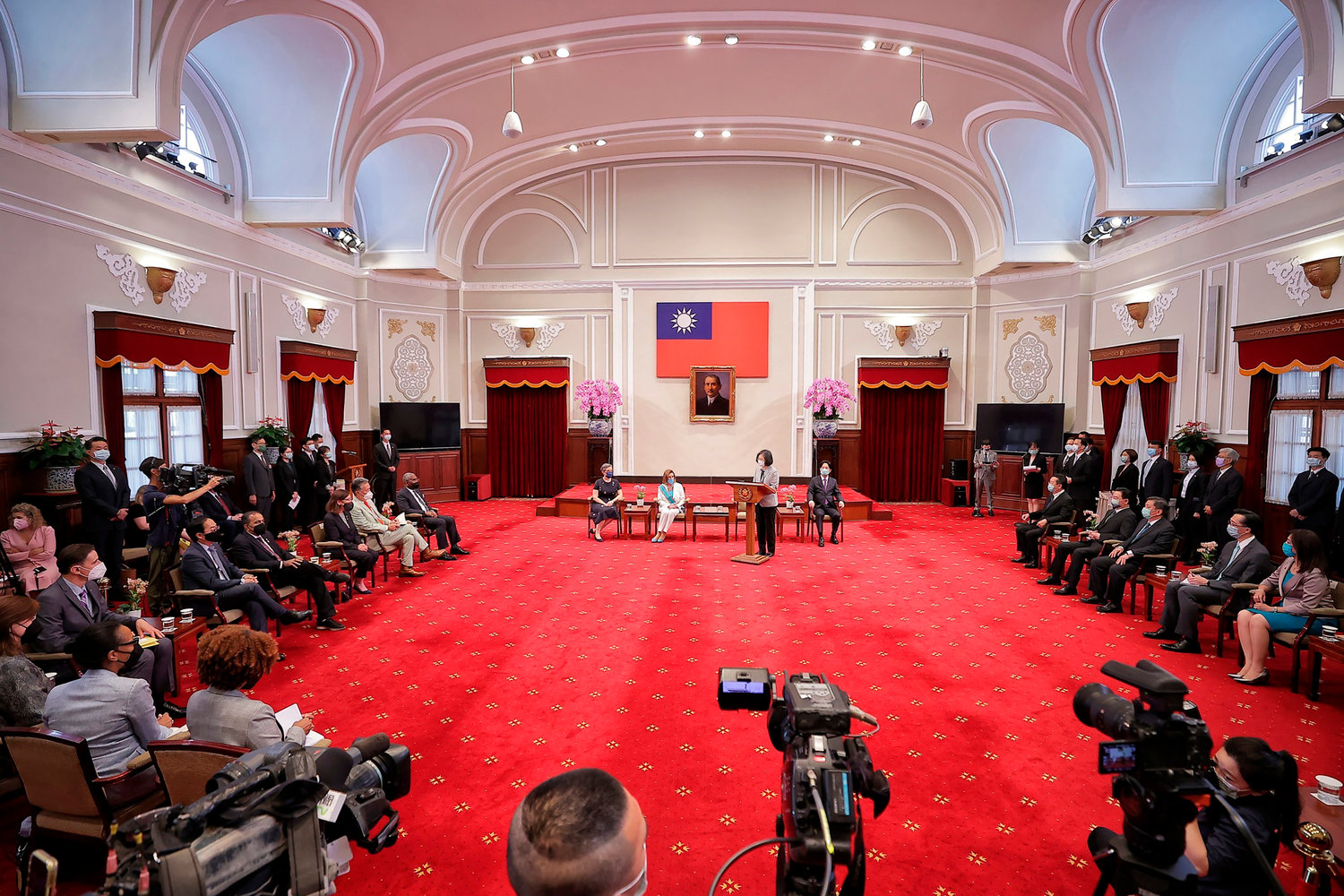In this photo released by the Taiwan Presidential Office, Taiwanese President President Tsai Ing-wen, standing, speaks during a meeting with U.S. House Speaker Nancy Pelosi and other members of Congress in Taipei, Taiwan, Wednesday, Aug. 3, 2022. U.S. House Speaker Nancy Pelosi, meeting top officials in Taiwan despite warnings from China, said Wednesday that she and other congressional leaders in a visiting delegation are showing they will not abandon their commitment to the self-governing island. (Taiwan Presidential Office via AP)