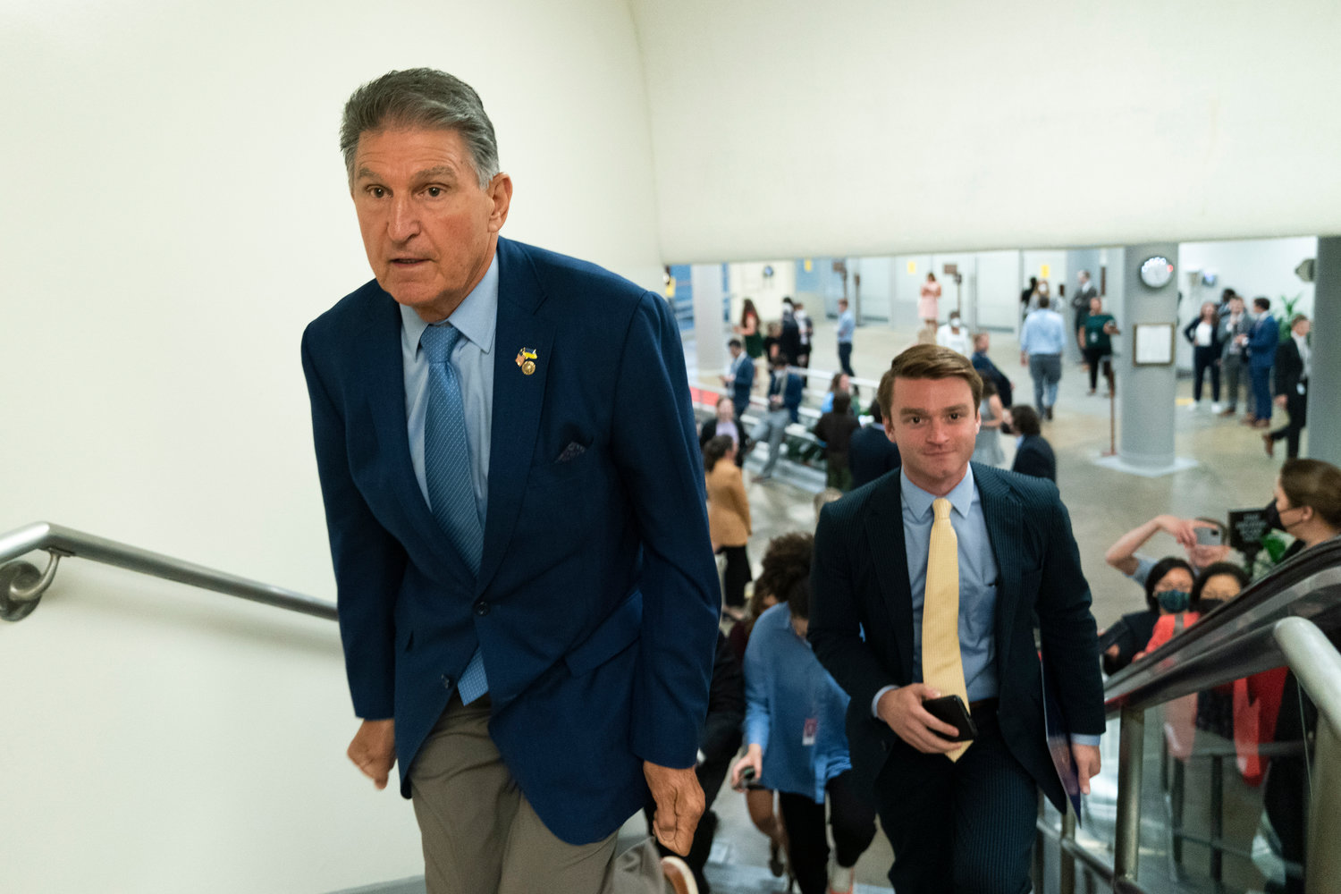 Journalists and staff follow Sen. Joe Manchin, D-W.Va., on Capitol Hill in Washington, Thursday, Aug. 4, 2022. (AP Photo/Manuel Balce Ceneta)