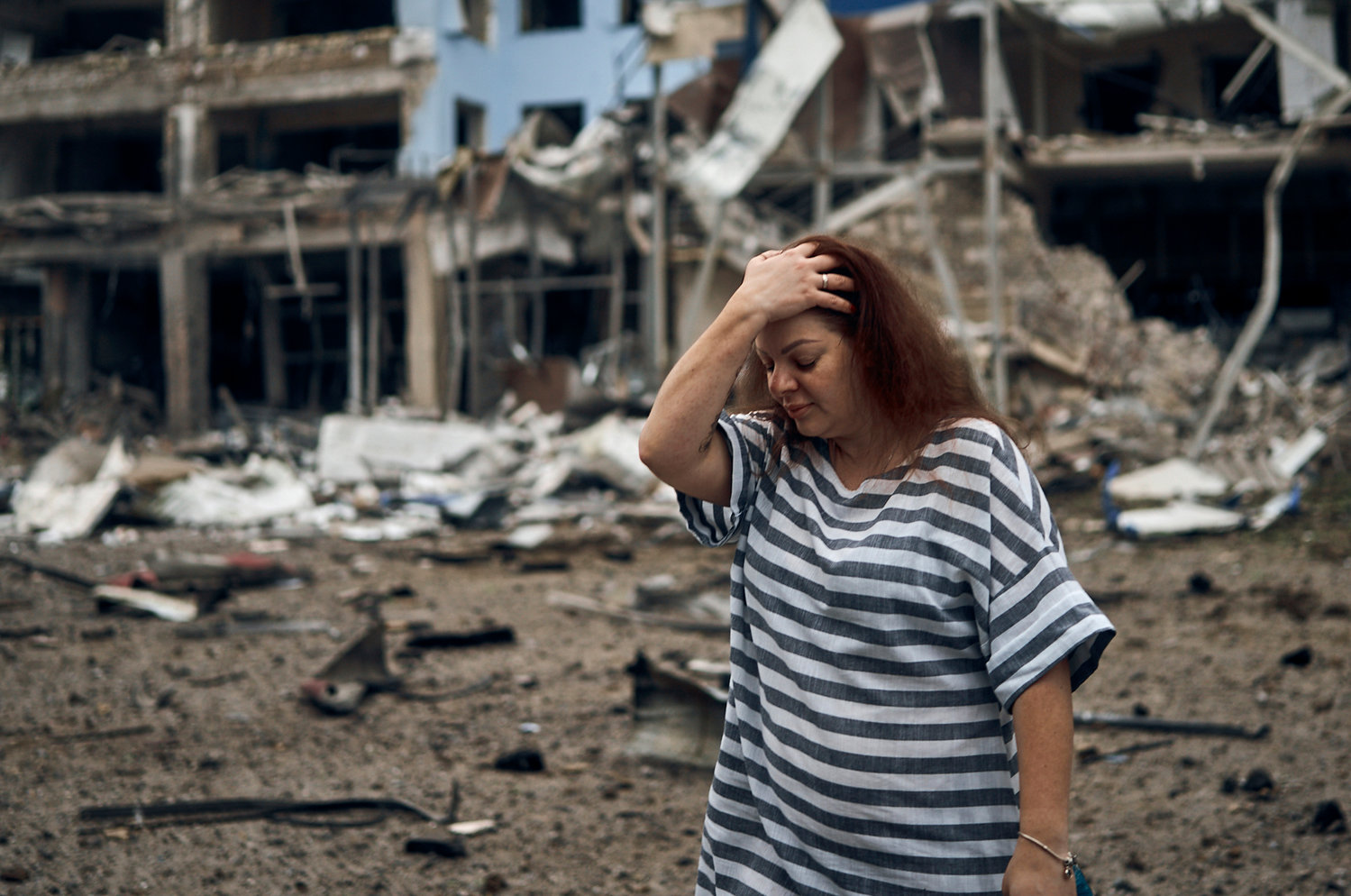 A woman stands amongst the debris after the Russian shelling in Mykolaiv, Ukraine, on Wednesday.