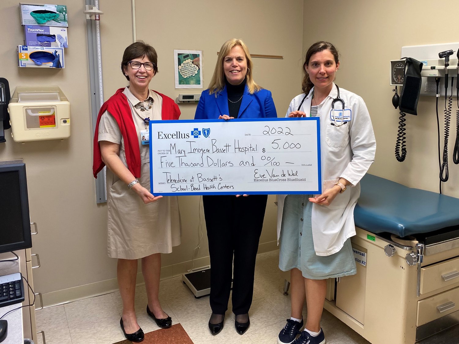 Jane Hamilton RN, practice manager, left, and Courtney Graham, FNP, right, accept a $5,000 grant on behalf of Bassett’s School-Based Health Center from Eve Van de Wal, Excellus BlueCross BlueShield Utica regional president. The funding will help the center expand its popular telehealth services.